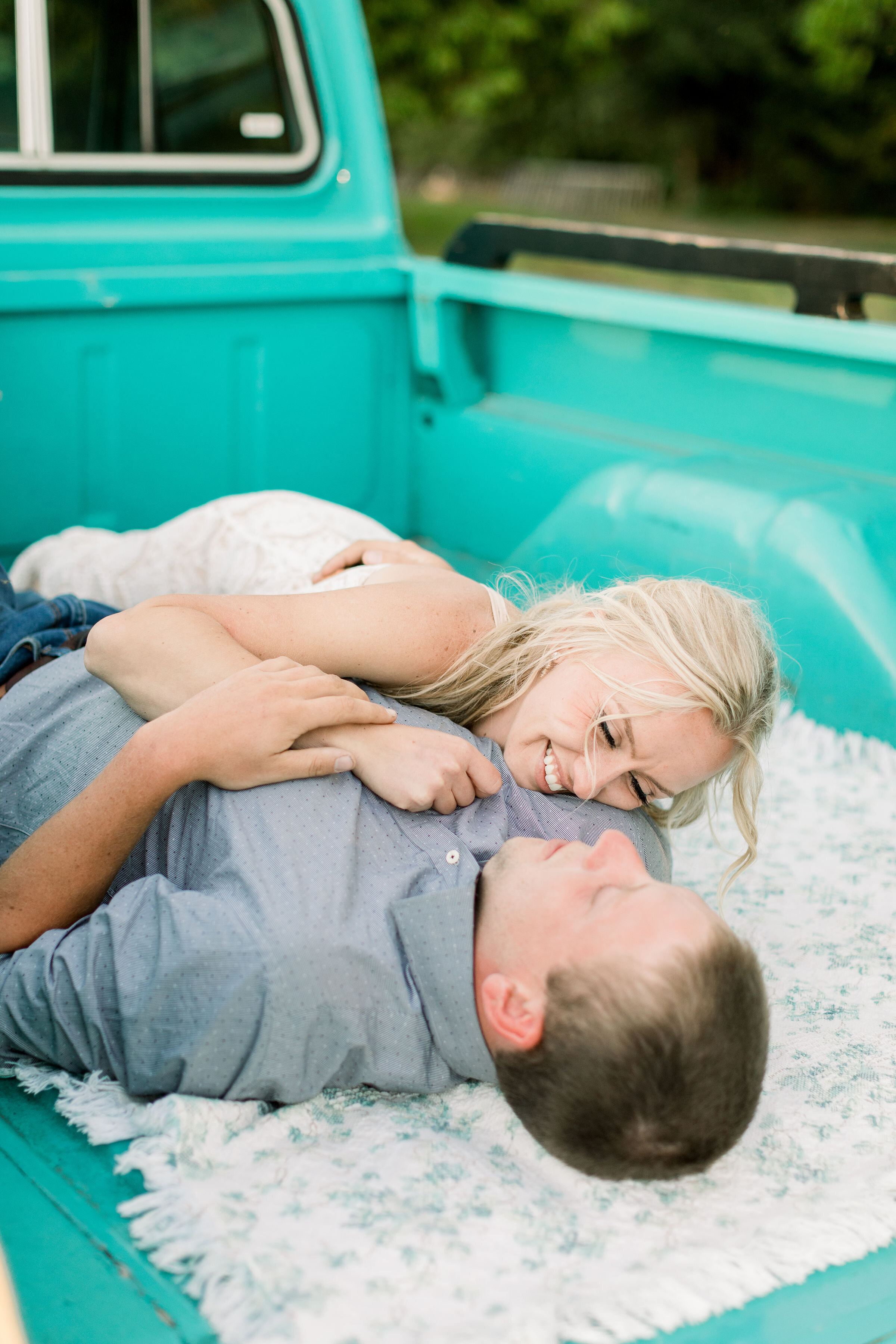  During this southern-styled engagement session in Ottawa, Canada, Chelsea Mason Photography captures this engaged couple playfully laying down in the bed of their Tiffany blue vintage ford pickup truck. vintage ford truck cuddling engagement #Chelse