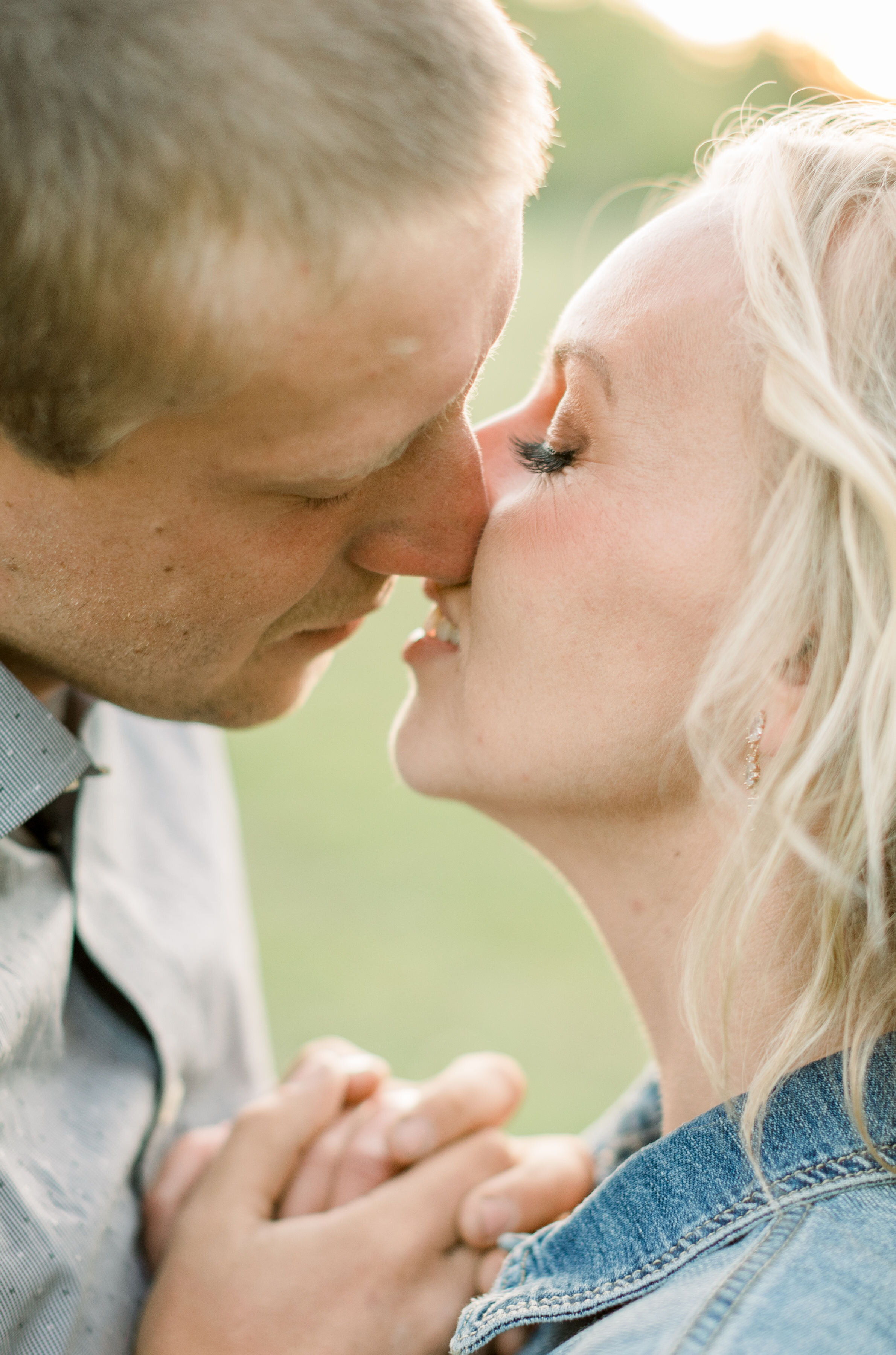 During this romantic southern-styled engagement session in Ottawa, Canada, Chelsea Mason Photography captures this groom leaning in to tenderly kiss his fiancé. couple kissing up close women's denim jacket women's blonde wild. engagement hair #Chels