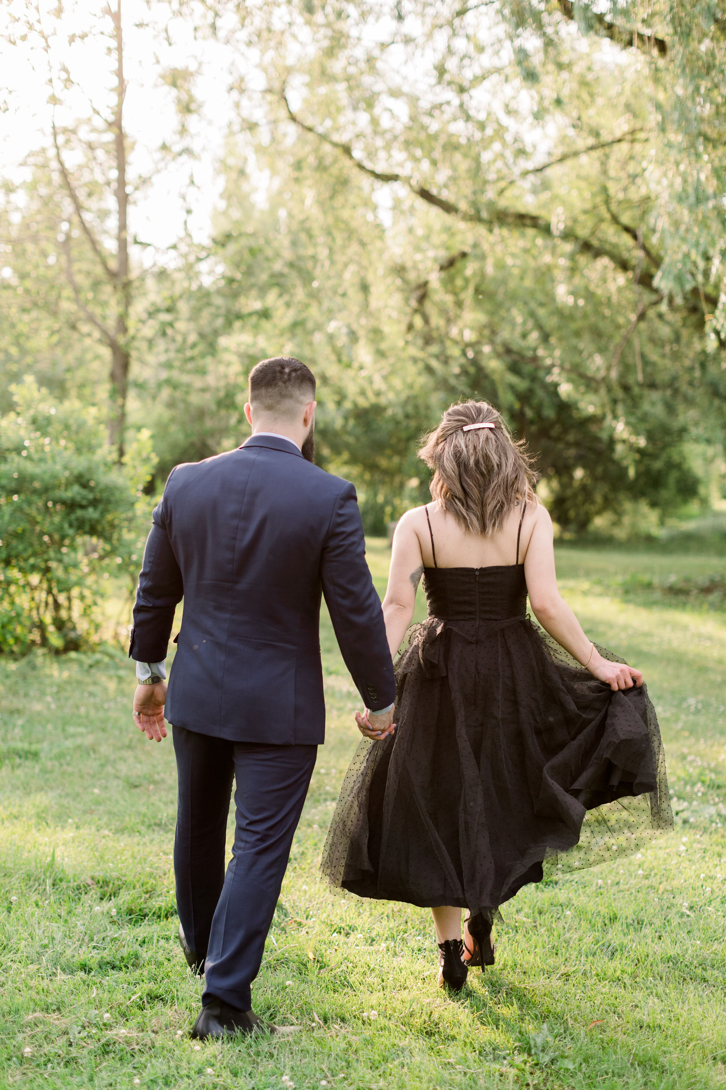  While walking through a shaded grassy park, Ottawa, Ontario photographer, Chelsea Mason Photography captures this formally dressed engaged couple holding hands. engaged couple holding hands formal black tie engagement photos womens black tea length 