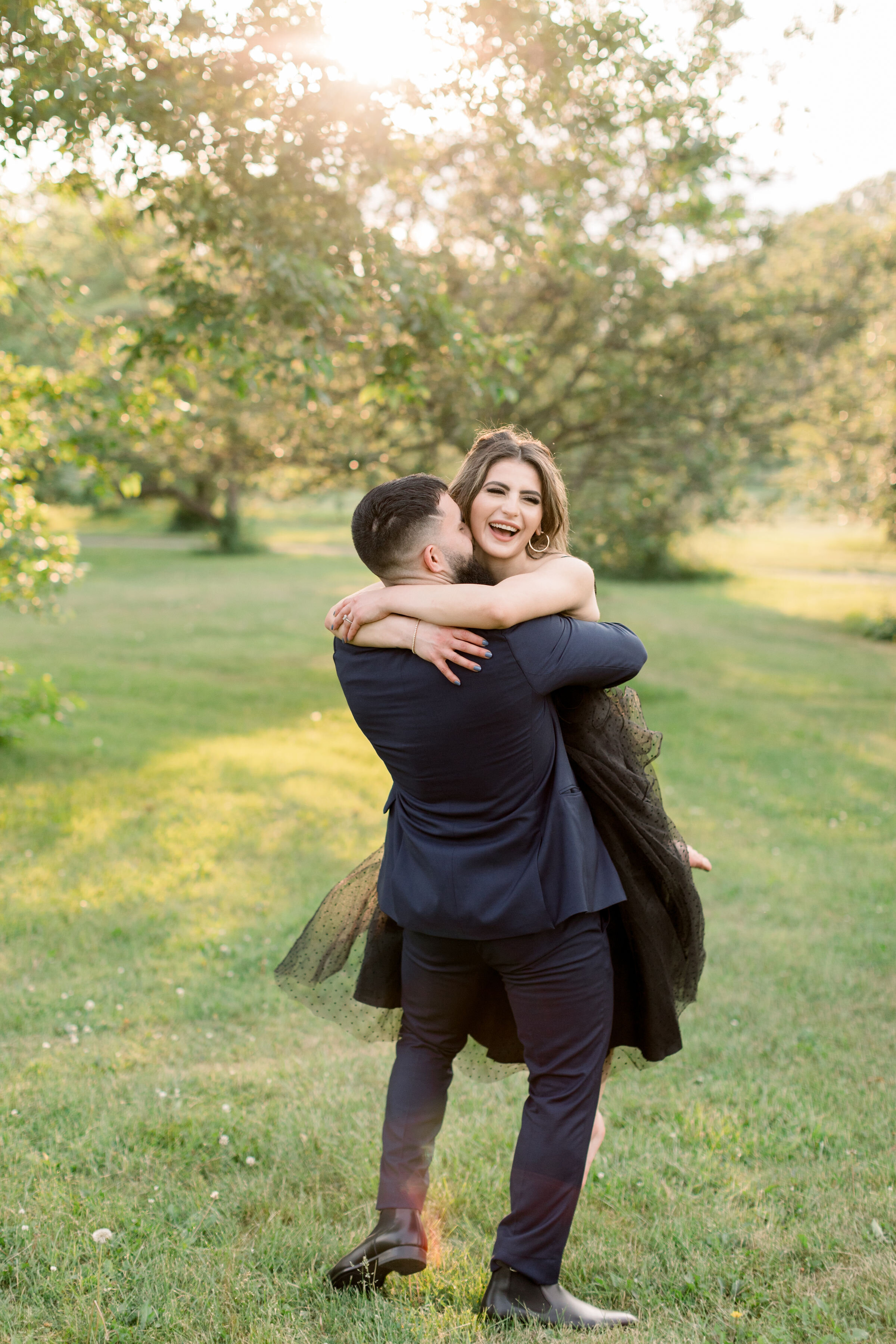  During this park engagement session in Ottawa, Canada, Chelsea Mason photography captures this soon-to-be groom playfully spinning his fiancé in circles. playful dancing engagement session in the park formal engagement wear Ottawa photographer #Chel