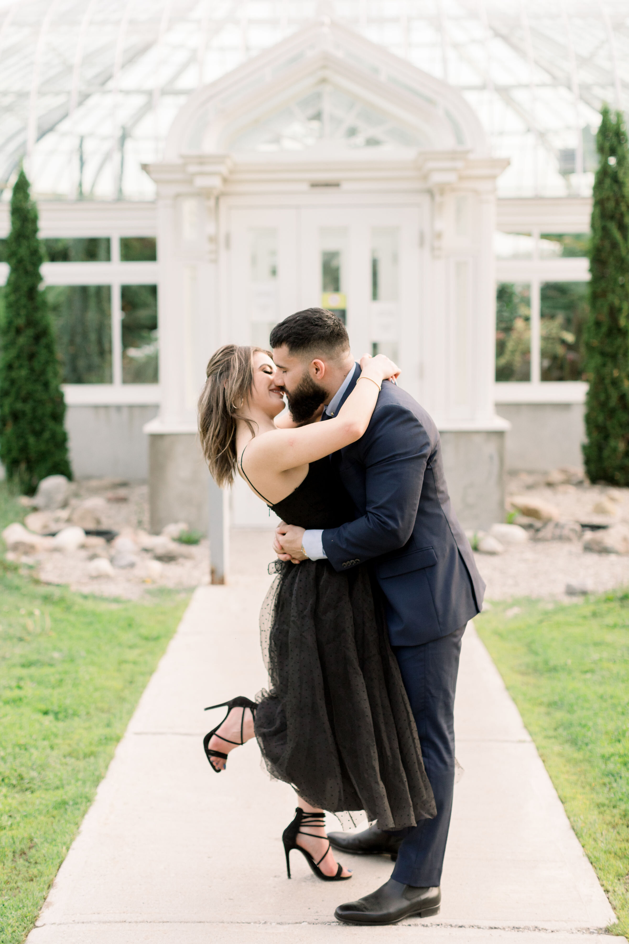  Romantically bending down for a kiss, Ottawa, Canada engagement photographer, Chelsea Mason Photography captures this soon-to-be groom holding his fiancé tightly while she pops her foot. pop foot kissing photo pose couples photographer Ottawa Canada