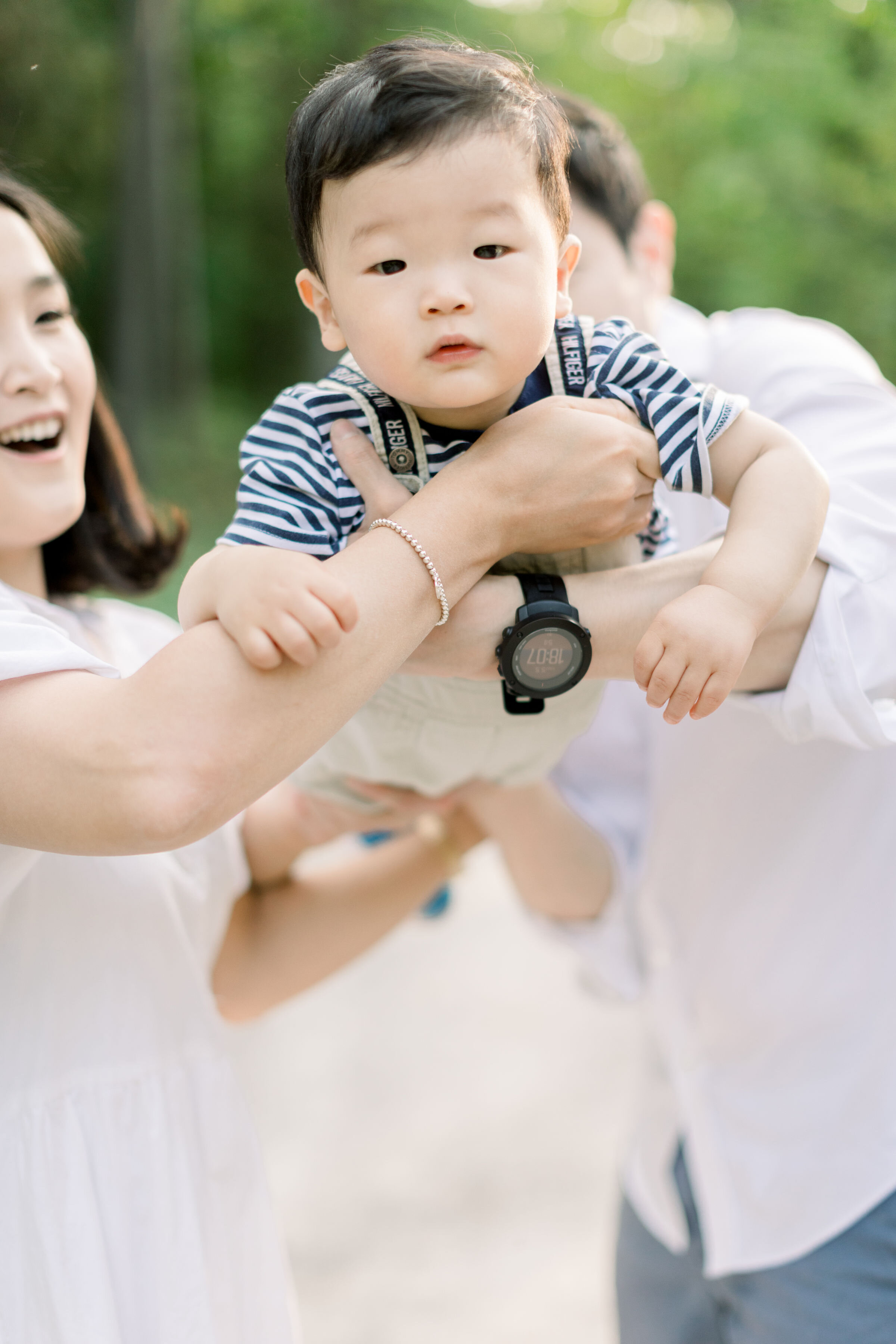  Ottawa, Ontario family photographer, Chelsea Mason Photography captures an up-close candid photo of this toddler boy being swung in the air by his parents. toddler boy playfully swung in air playful family photo poses Ottawa Ontario photographer #Al