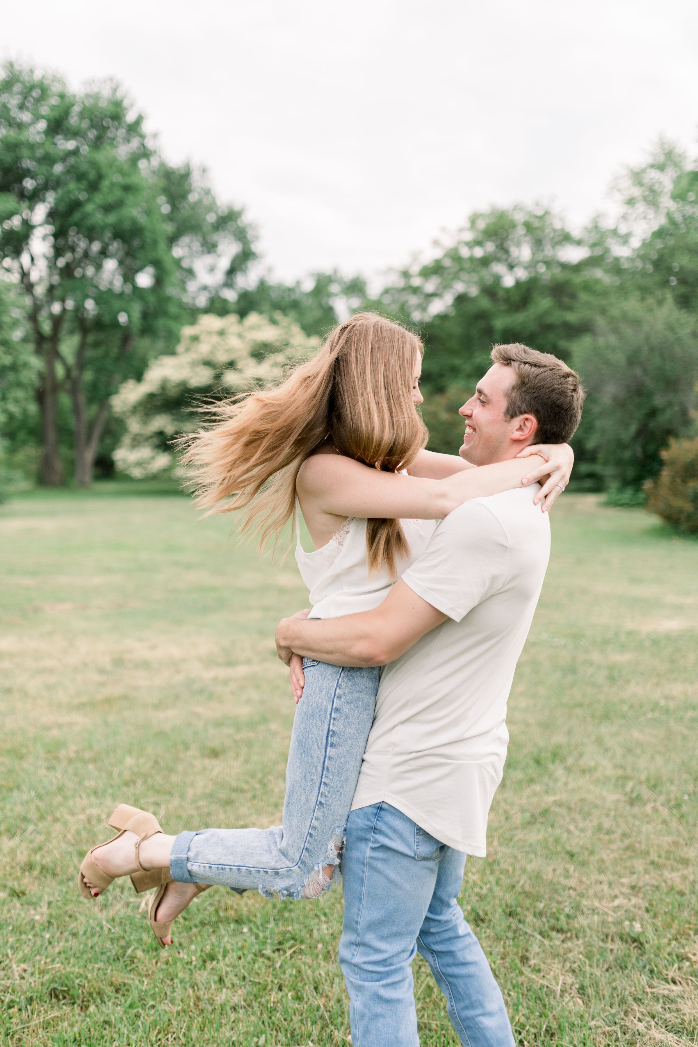  During this playful engagement session with Chelsea Mason Photography in Ottawa, Ontario, this soon-to-be groom picks up his fiancé and spins. playful engagement poses groom picks up wife couples posing Ottawa photographer #ChelseaMasonPhotography #