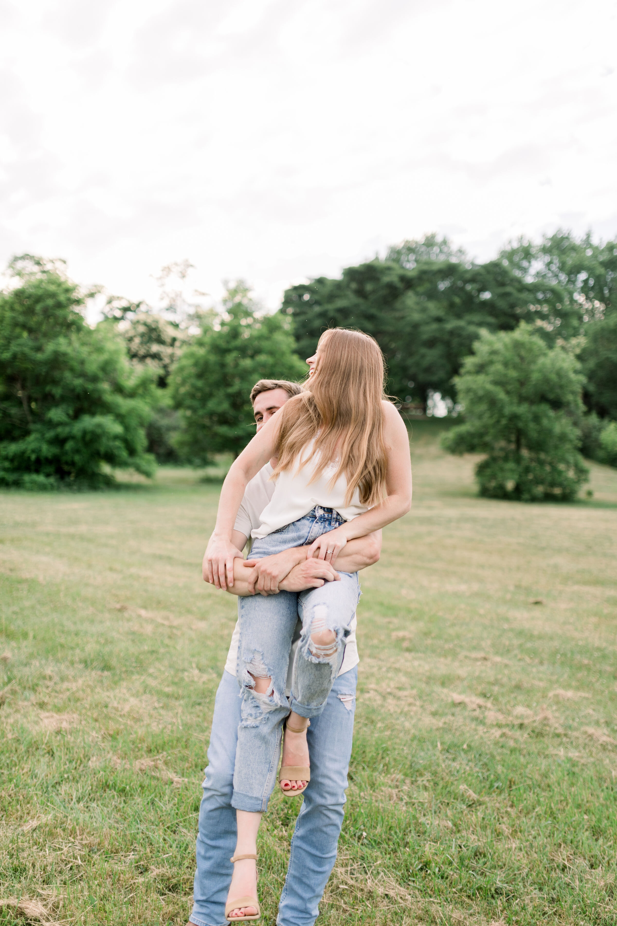  During this playful engagement session, Ottawa, Ontario photographer, Chelsea Mason Photography captures this soon-to-be groom picking up his fiancé playfully. groom picking up fiancé playful couples poses Ottawa engagement photographer #ChelseaMaso