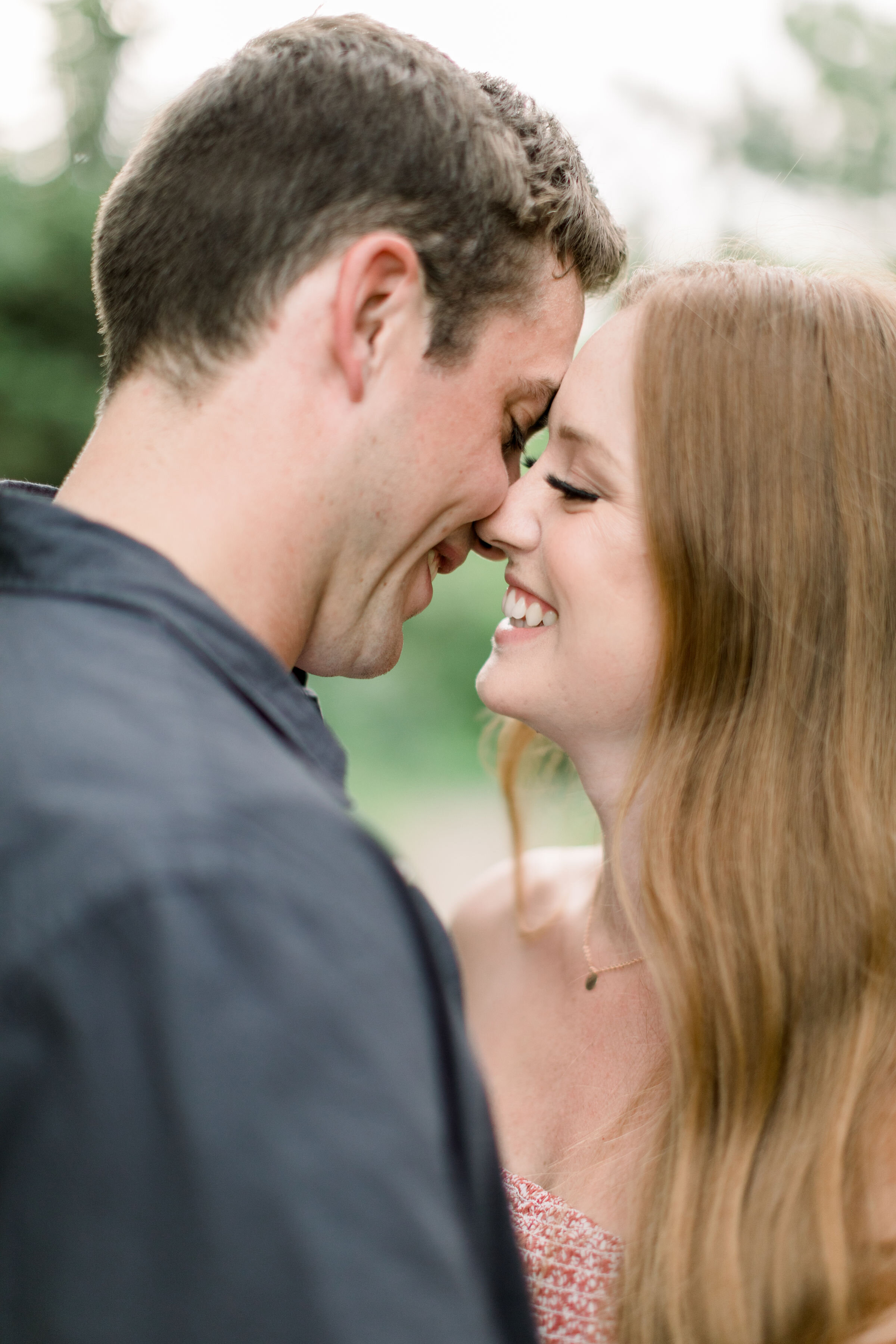  Arboretum, Ottawa photographer, Chelsea Mason Photography captures this couple playfully nuzzling noses while learning in for a smiling kiss. playful kissing couples photos engagement poses arboretum Ottawa photographer #ChelseaMasonPhotography #The