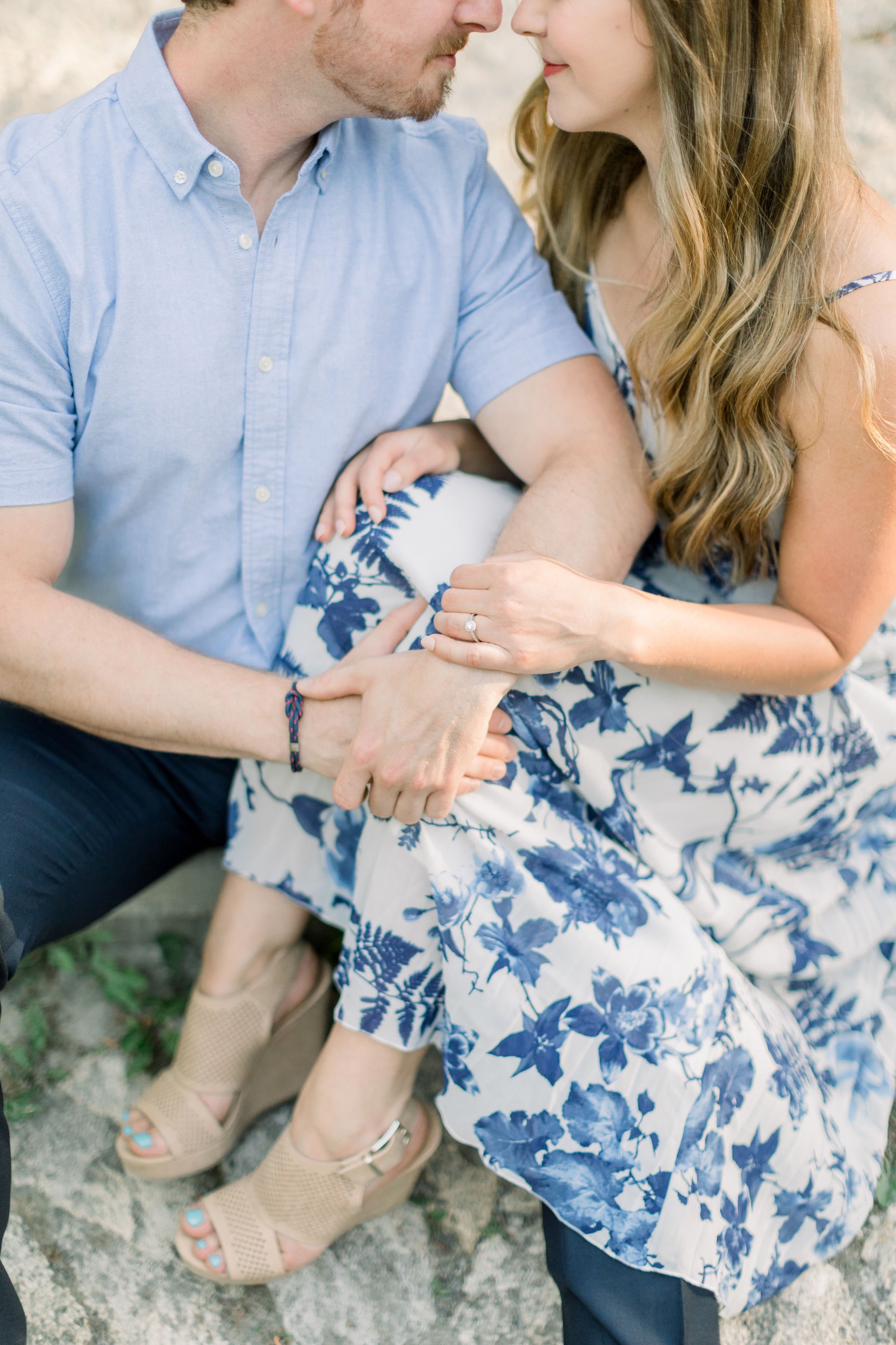  In Almonte Chelsea Mason Photography captures a close-up of an engaged couple on a tree stump. blue engagements summer engagement #chelseamasonphotography #chelseamasonengagements #OttawaEngagements #Almonteengagementphotographer #outdoorengagments 