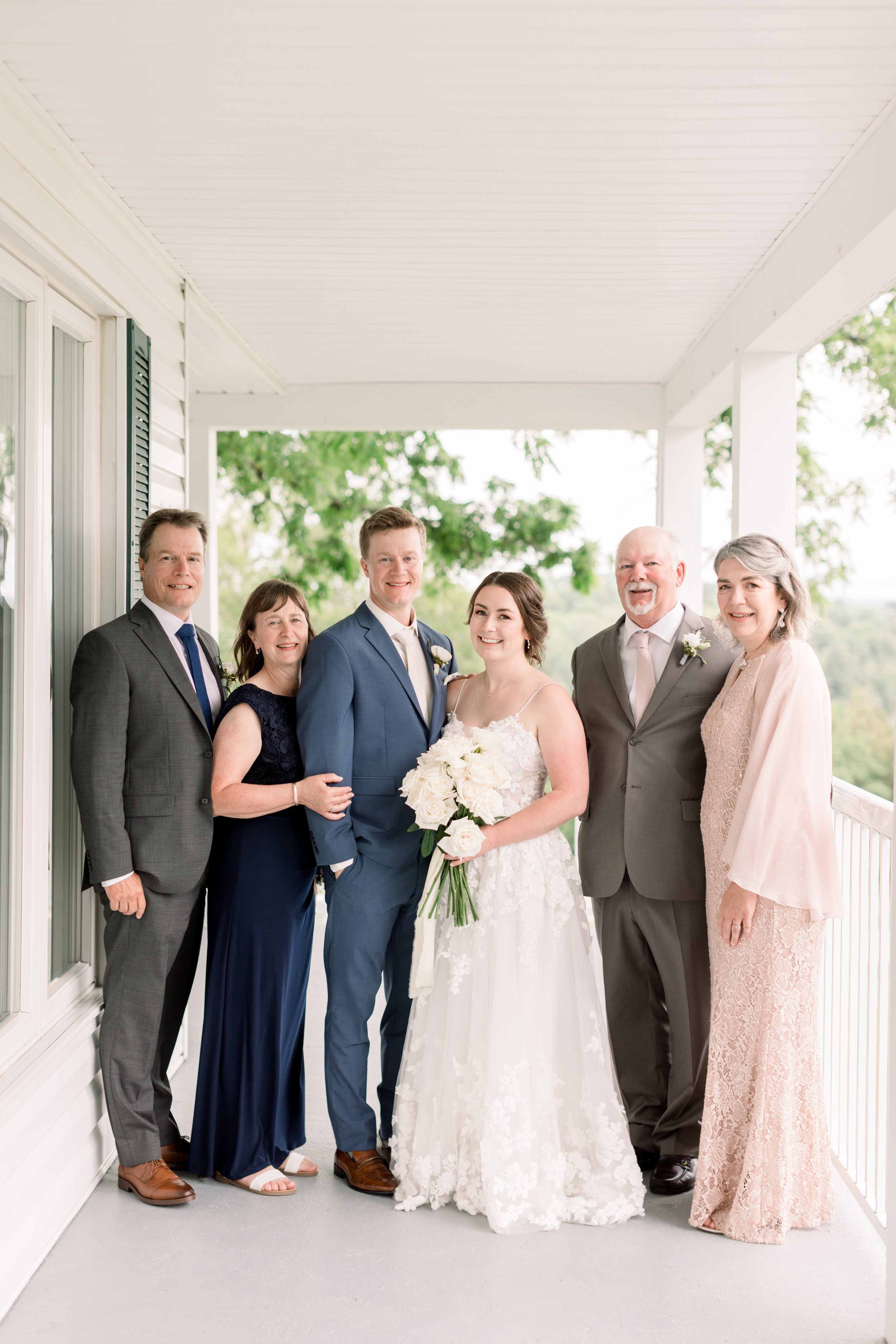  Chelsea Mason Photography captures a portrait of the bride and groom with their parents during a wedding in Ontario. wedding portraits parent #chelseamasonphotography #chelseamasonweddings #Ontarioweddings #Boulterweddingphotographer #laceweddinggow