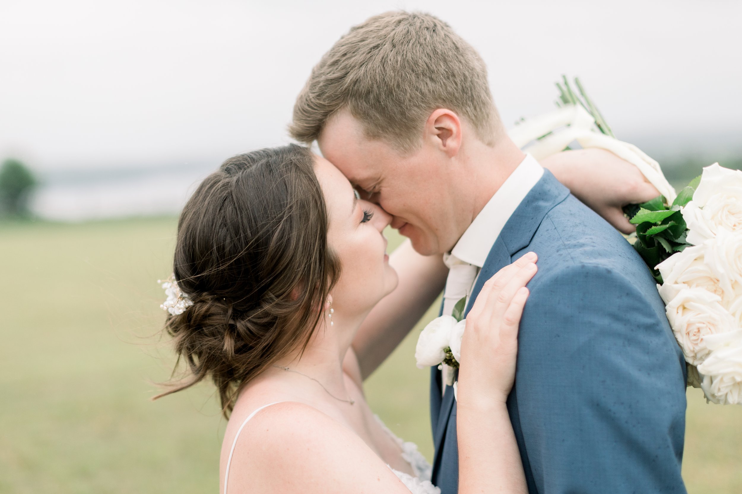  Bride and groom kiss on a cloudy wedding day in Ontario by Chelsea Mason Photography. Boulter wedding photographer kissing newlyweds #chelseamasonphotography #chelseamasonweddings #Ontarioweddings #Boulterweddingphotographer #laceweddinggown 