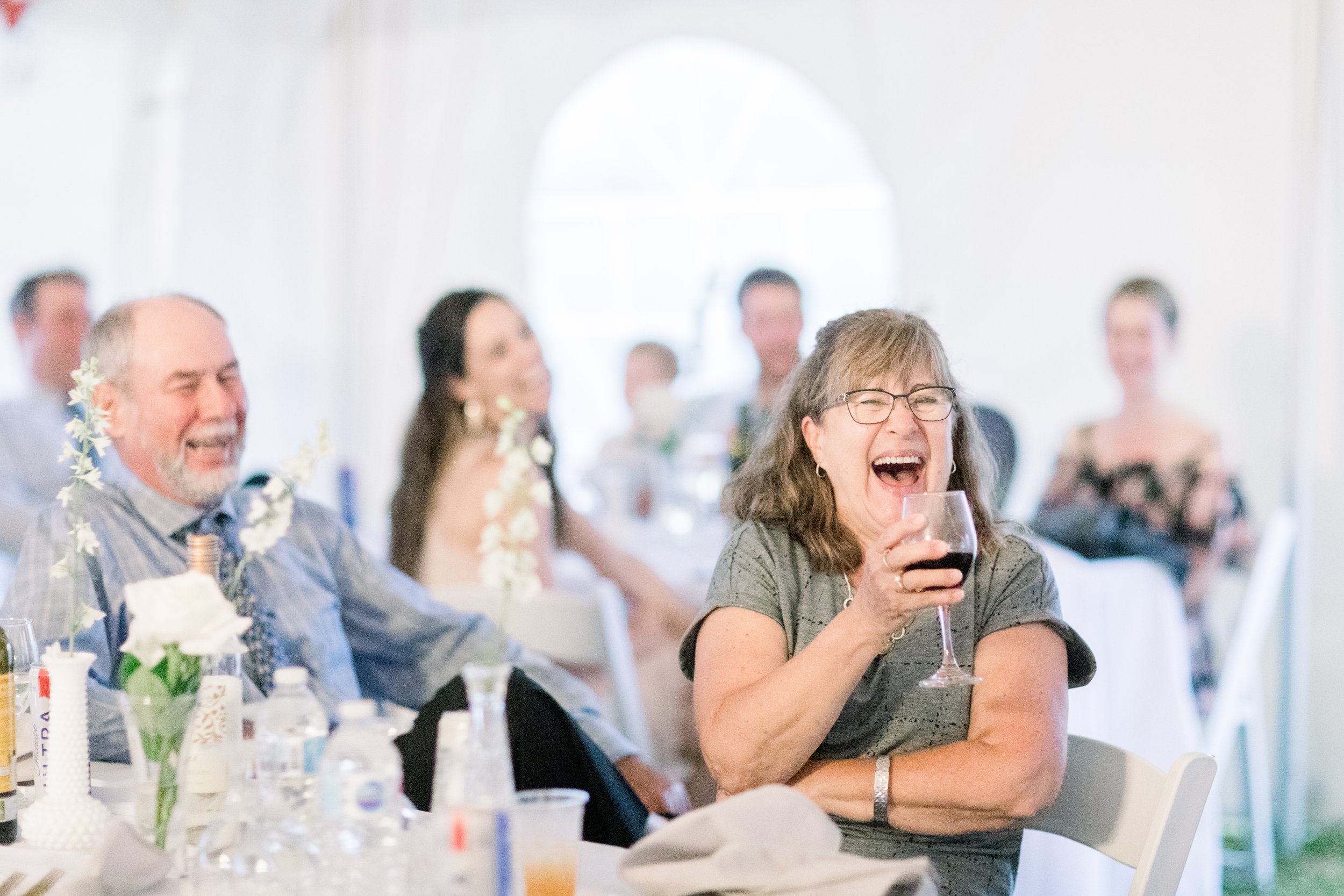  During a wedding in Boulter, Ontario Chelsea Mason Photography captures wedding guests toasting. wedding guest portraits Boulter weddings #chelseamasonphotography #chelseamasonweddings #Ontarioweddings #Boulterweddingphotographer #laceweddinggown 