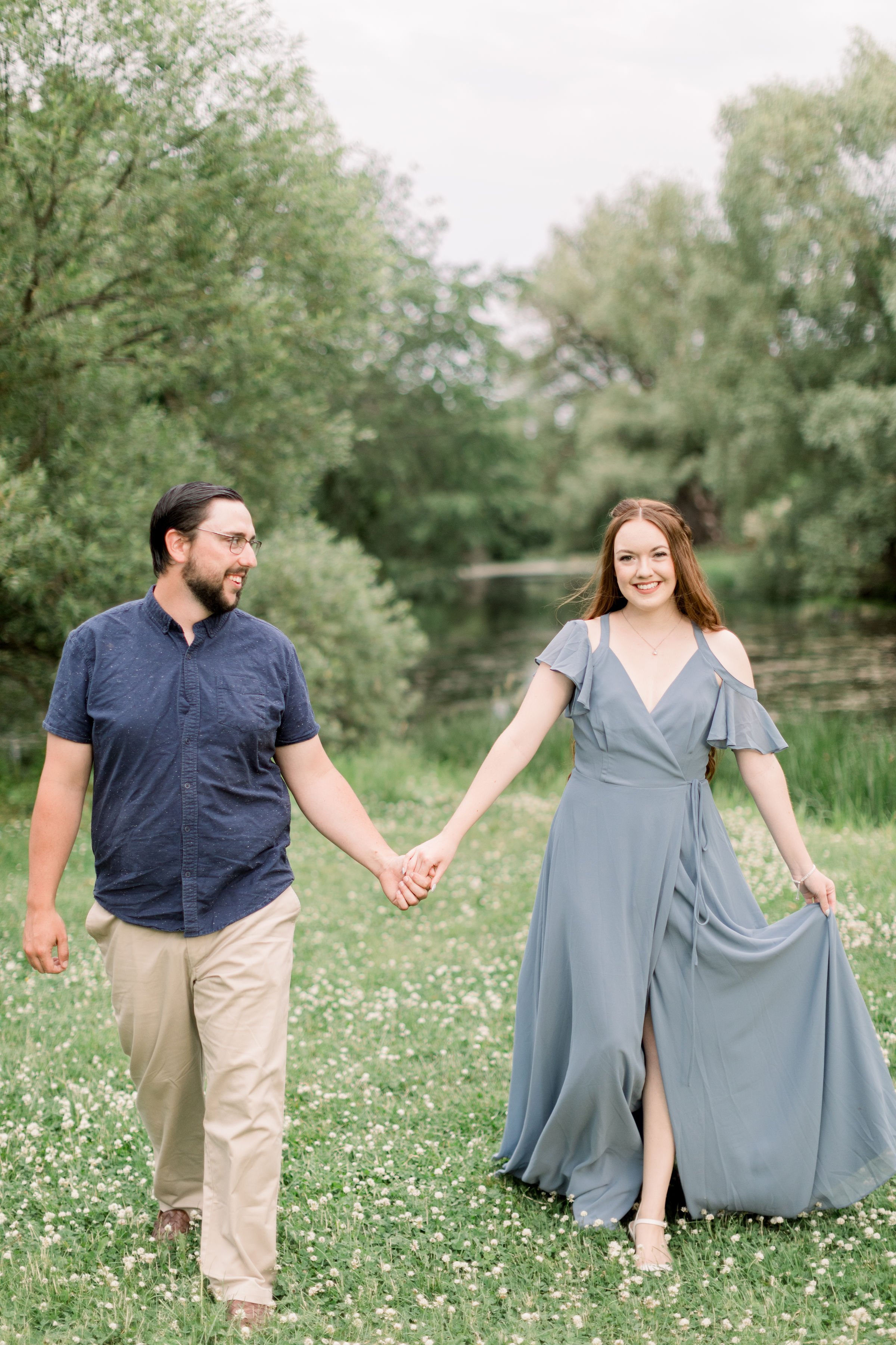  A red-haired woman in a blue dress smiles during an engagement session with Chelsea Mason Photography. engagement style ideas red hair #chelseamasonphotography #chelseamasonengagements #Ottawaengagements #DominonArboretum #Ottawaphotographers 