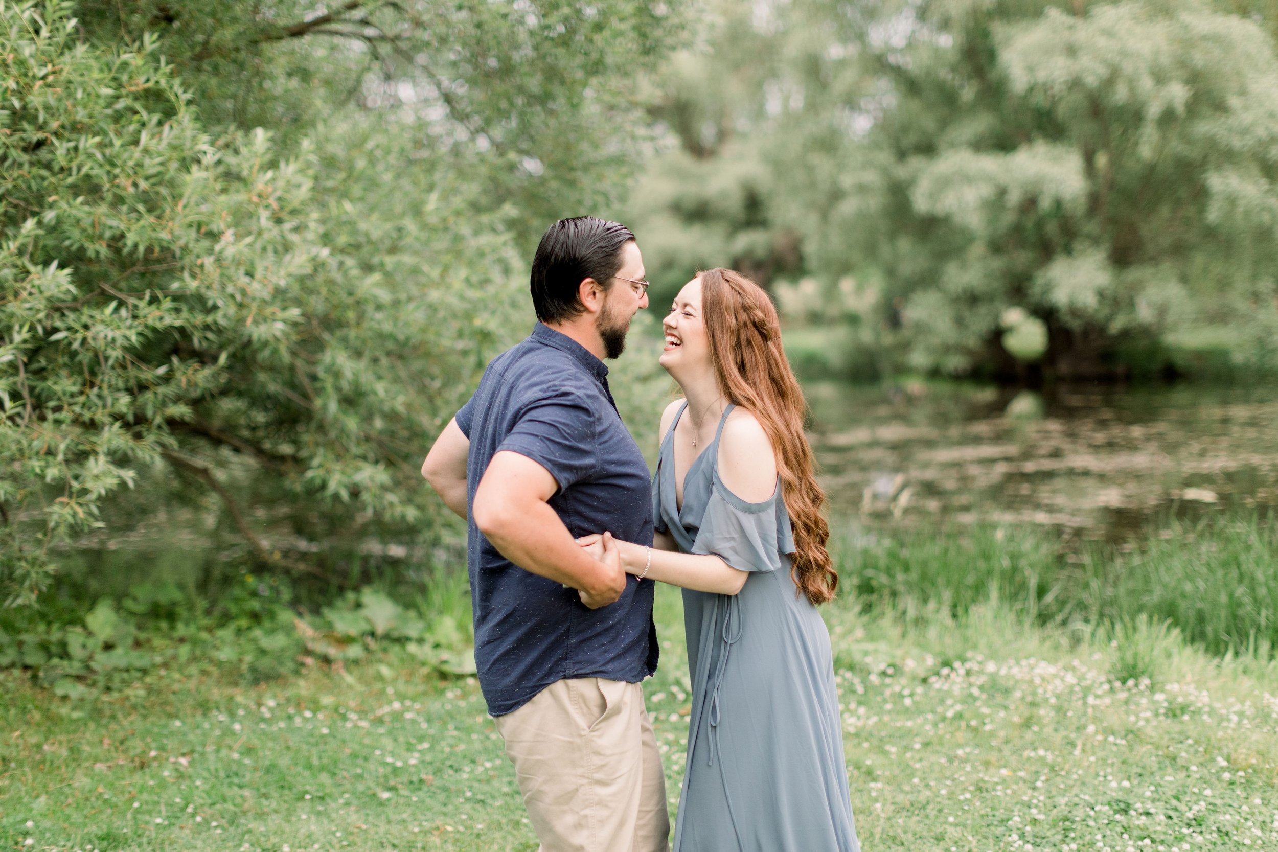 At the Dominion Arboretum in Ottawa, an engaged couple laughs and plays by Chelsea Mason Photography. laughing engaged couple Ottawa #chelseamasonphotography #chelseamasonengagements #Ottawaengagements #DominonArboretum #Ottawaphotographers 