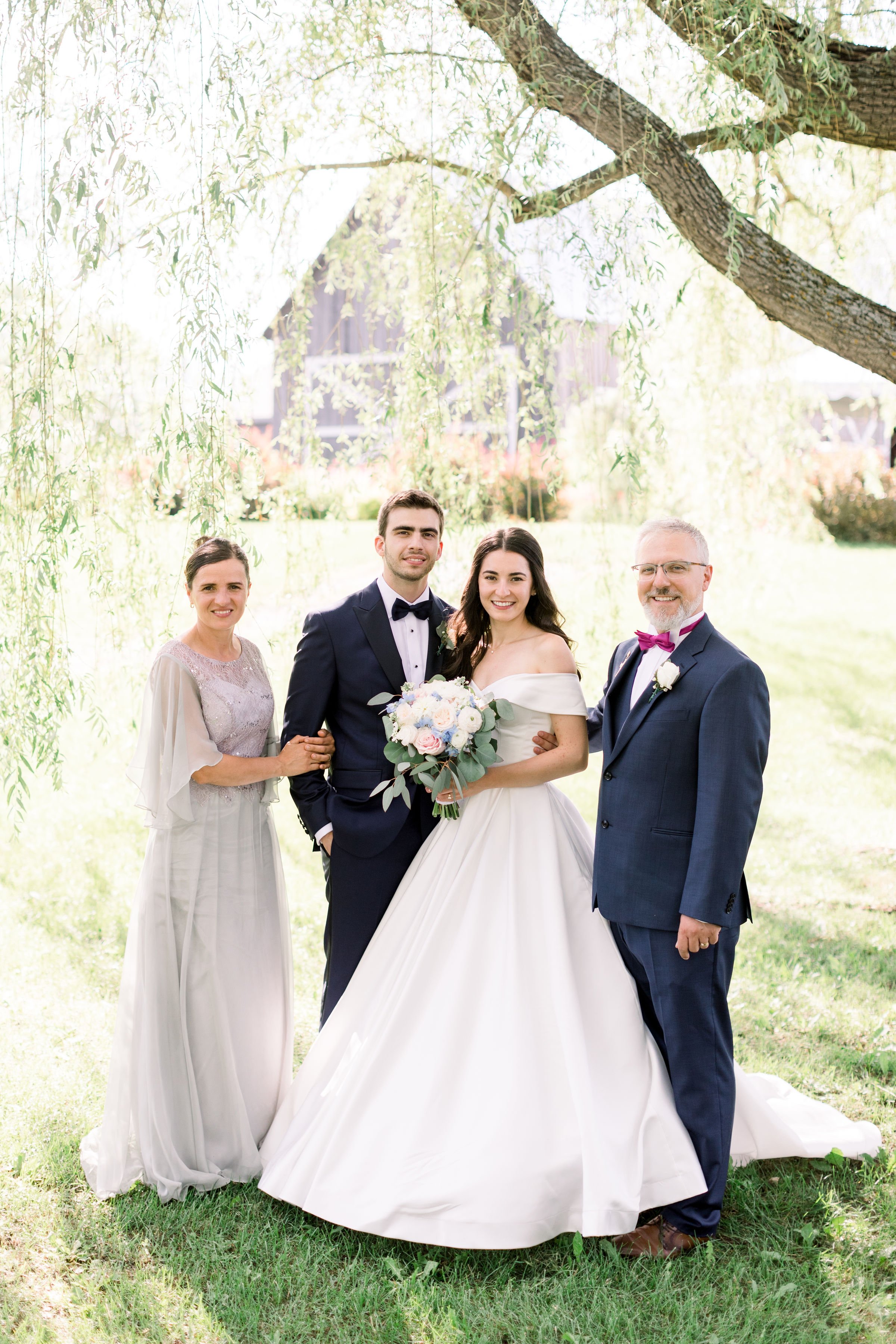  Chelsea Mason Photography captures a bride and groom with their parents under a vine tree in Almonte. Evermore wedding events #Chelseamasonphotography #Chelseamasonweddings #Onatarioweddings #EvermoreweddingsAlmonte #Ontarioweddingphotographers 