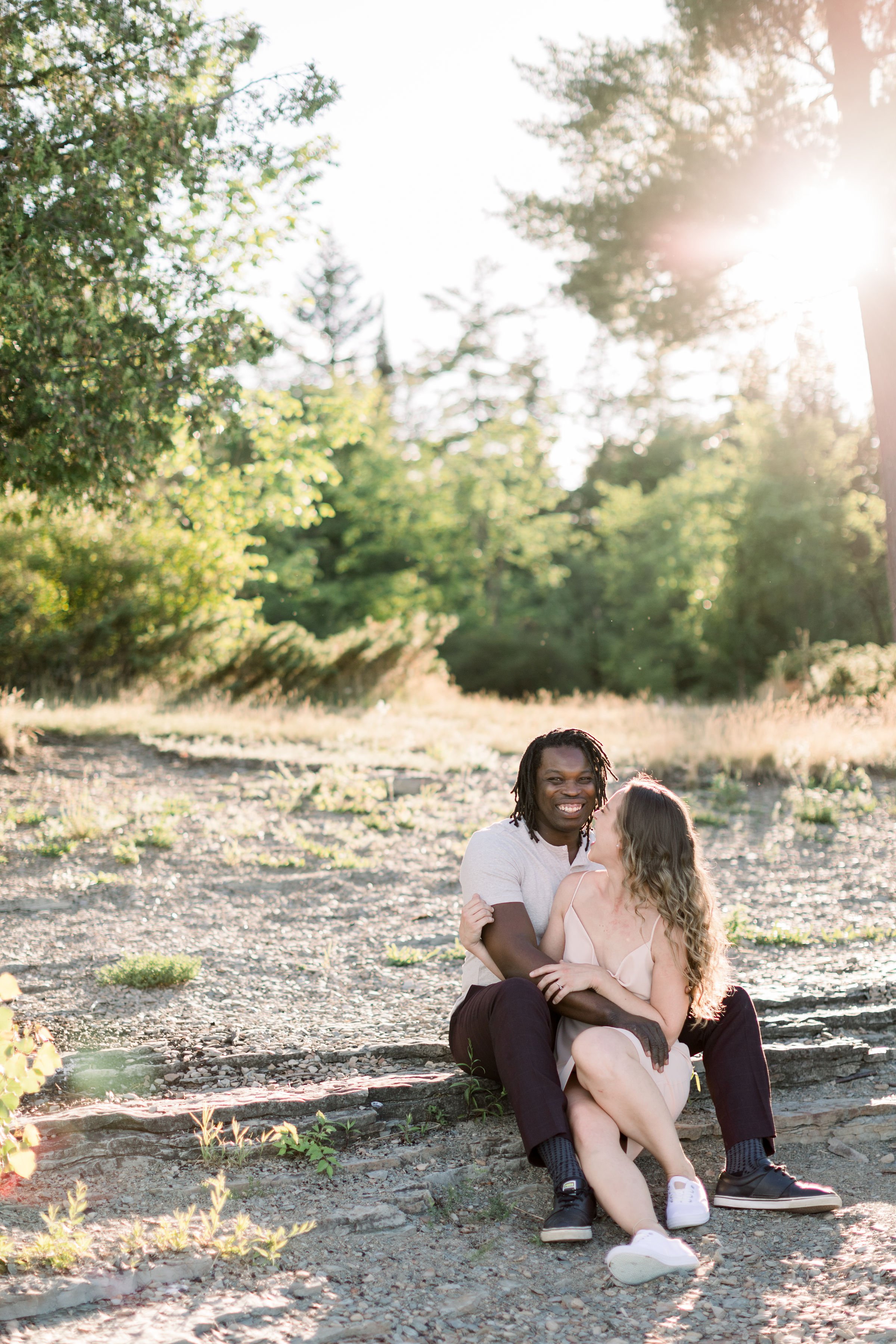  At Pinhey's Point at sunset fiances hold each other tight and smile by Chelsea Mason Photography. Pinhey's Point photography #Chelseamasonphotography #Chelseamasonengagements #Onatarioengagements #Pinhey'sPoint #Ontarioweddingphotographers 