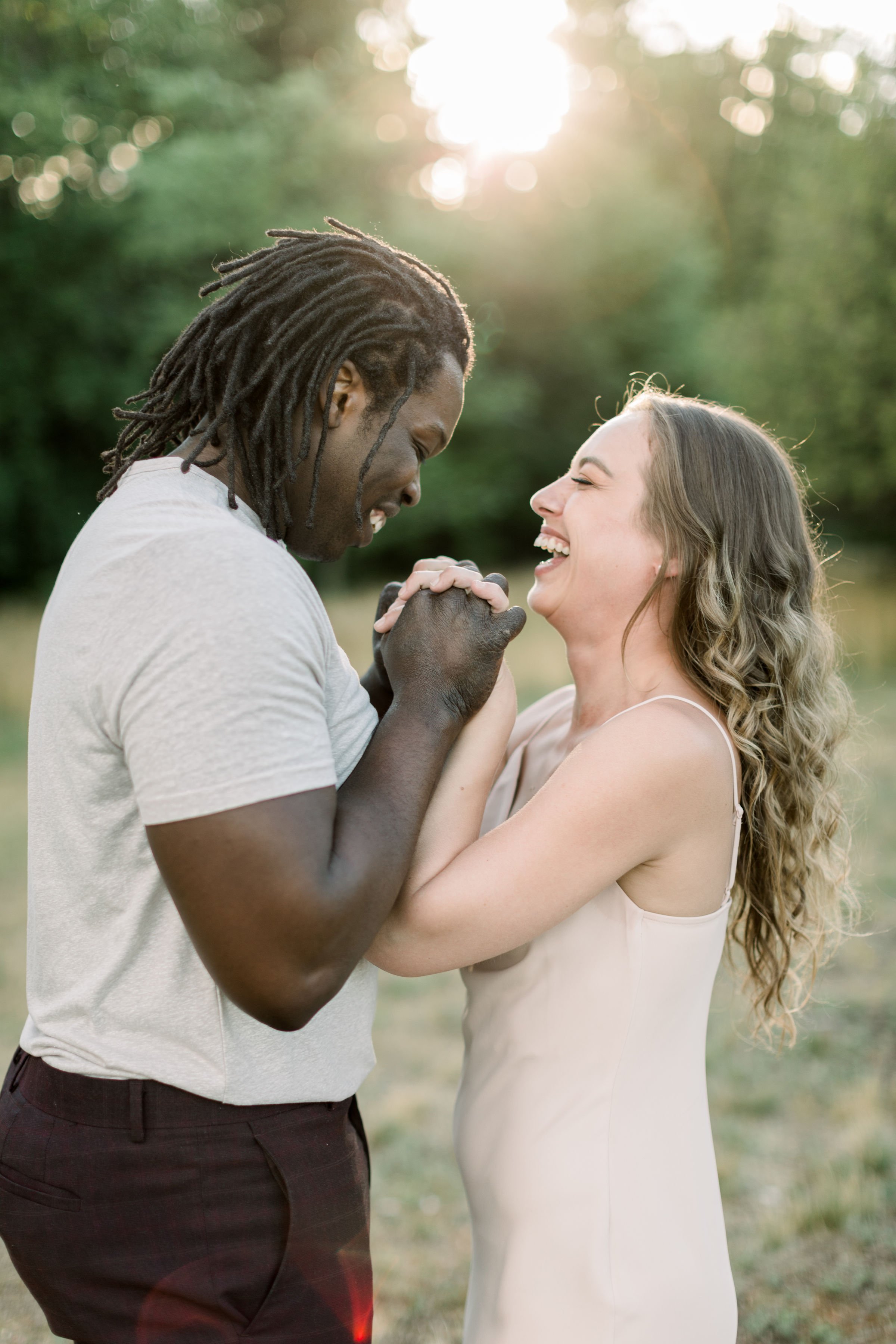  At sunset at Pinhey's Point, an engaged couple laughs while holding hands by Chelsea Mason Photography. laughing fiances sunset picture #Chelseamasonphotography #Chelseamasonengagements #Onatarioengagements #Pinhey'sPoint #Ontarioweddingphotographer