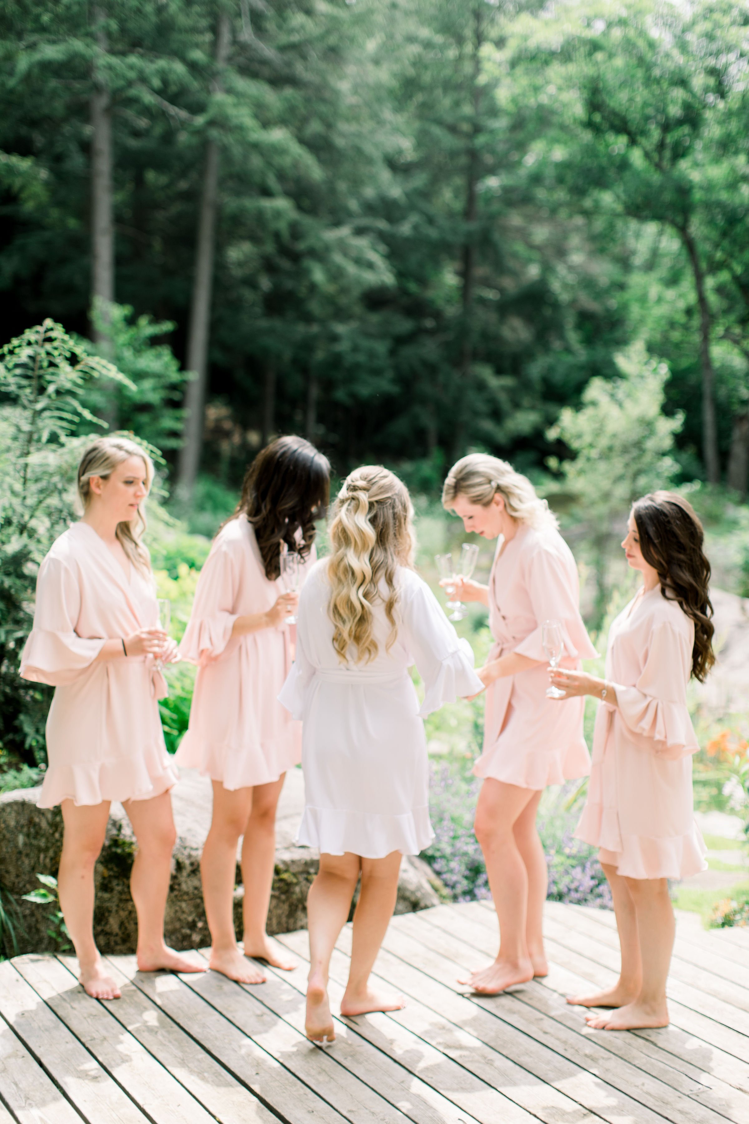  Bridesmaids in silk matching robes celebrate with the bride captured by Chelsea Mason Photography. silk matching bridesmaids robes #Quebecweddings #elegantoutdoorwedding #Quebecweddingphotographers #Chelseamasonphotography #Chelseamasonweddings 