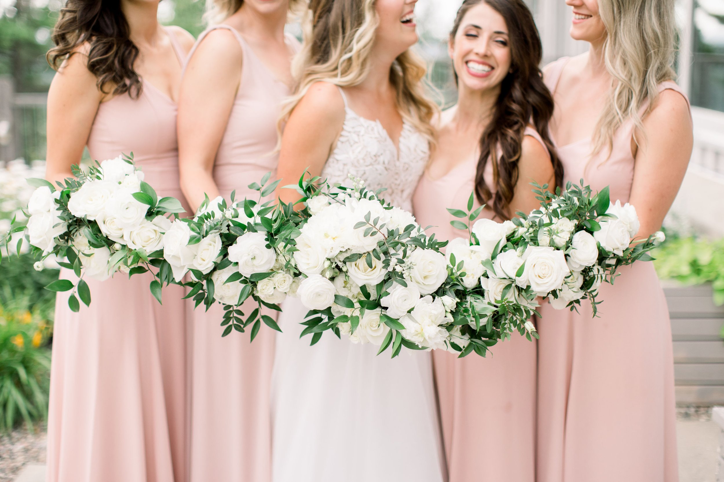  The bride laughs with her bridesmaids all wearing light pink by Chelsea Mason Photography. light pink dresses summer wedding bridesmaid #Quebecweddings #elegantoutdoorwedding #Quebecweddingphotographers #Chelseamasonphotography #Chelseamasonweddings