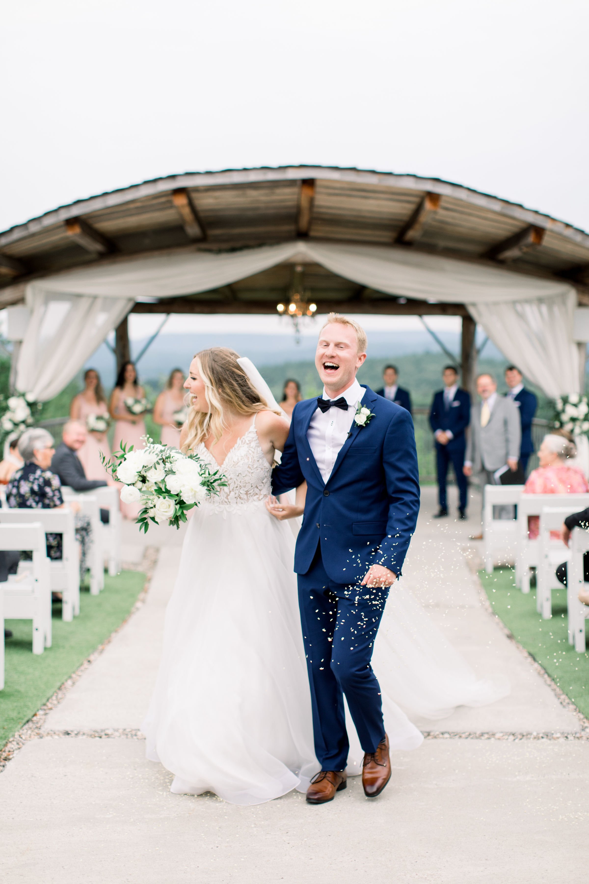  Groom and bride laugh as wedding guests throw rice while they walk down the aisle by Chelsea Mason Photography. rice throw aisle walk #Quebecweddings #elegantoutdoorwedding #Quebecweddingphotographers #Chelseamasonphotography #Chelseamasonweddings 