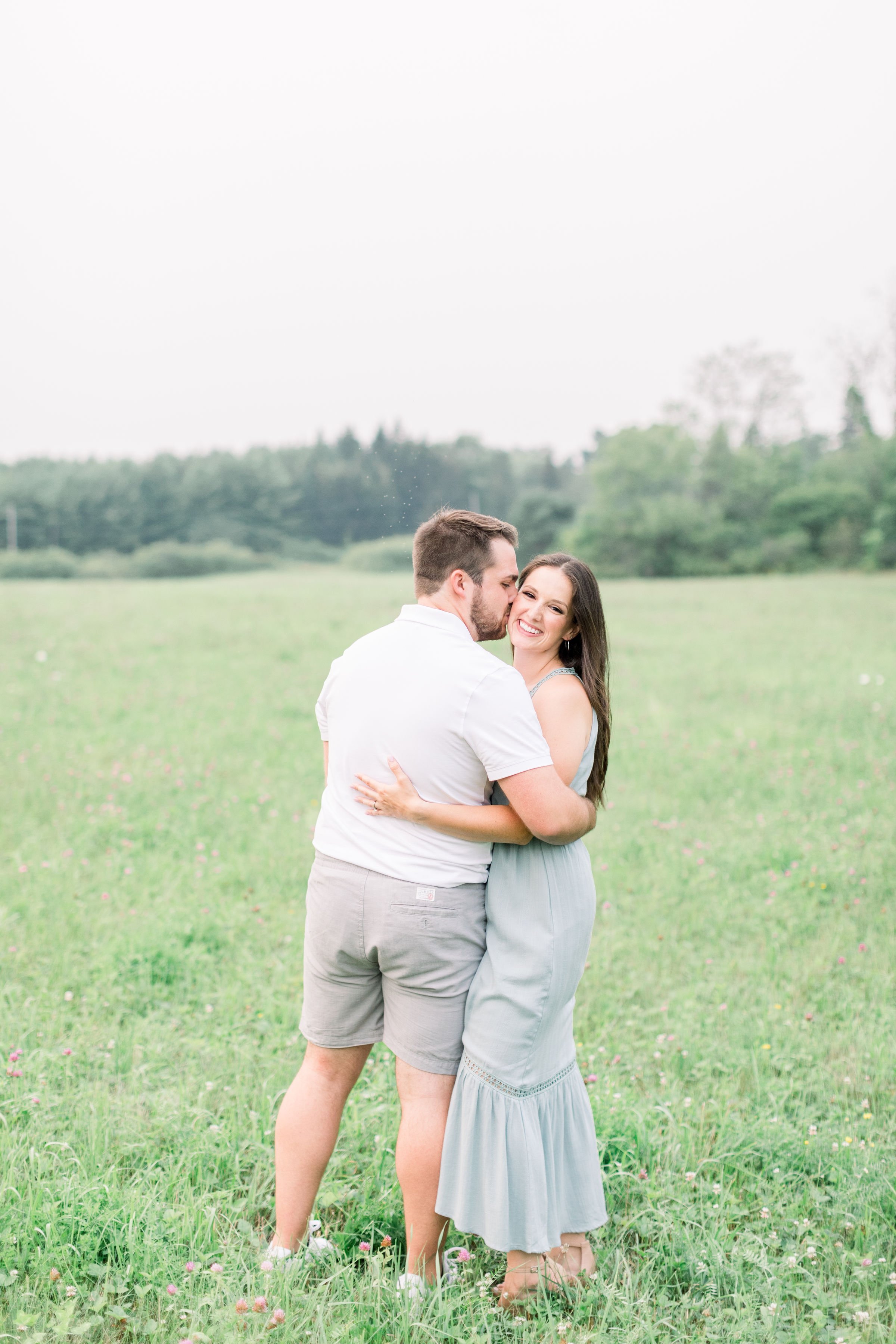  Ontario engagement photographer captures a man kissing his fiance's cheek by Chelsea Mason Photography. she said yes kisses #Kingstonengagement #GrassCreekParkPortraits #Ontarioengagementphotographers #Chelseamasonphotography #Chelseamasonengagement