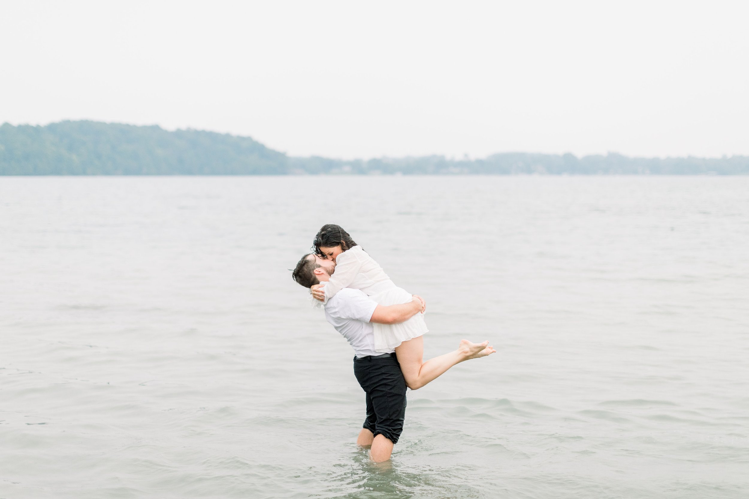  Chelsea Mason Photography captures engagements with a couple standing in the middle of a lake. Grass Creek Park engagement #Kingstonengagement #GrassCreekParkPortraits #Ontarioengagementphotographers #Chelseamasonphotography #Chelseamasonengagements