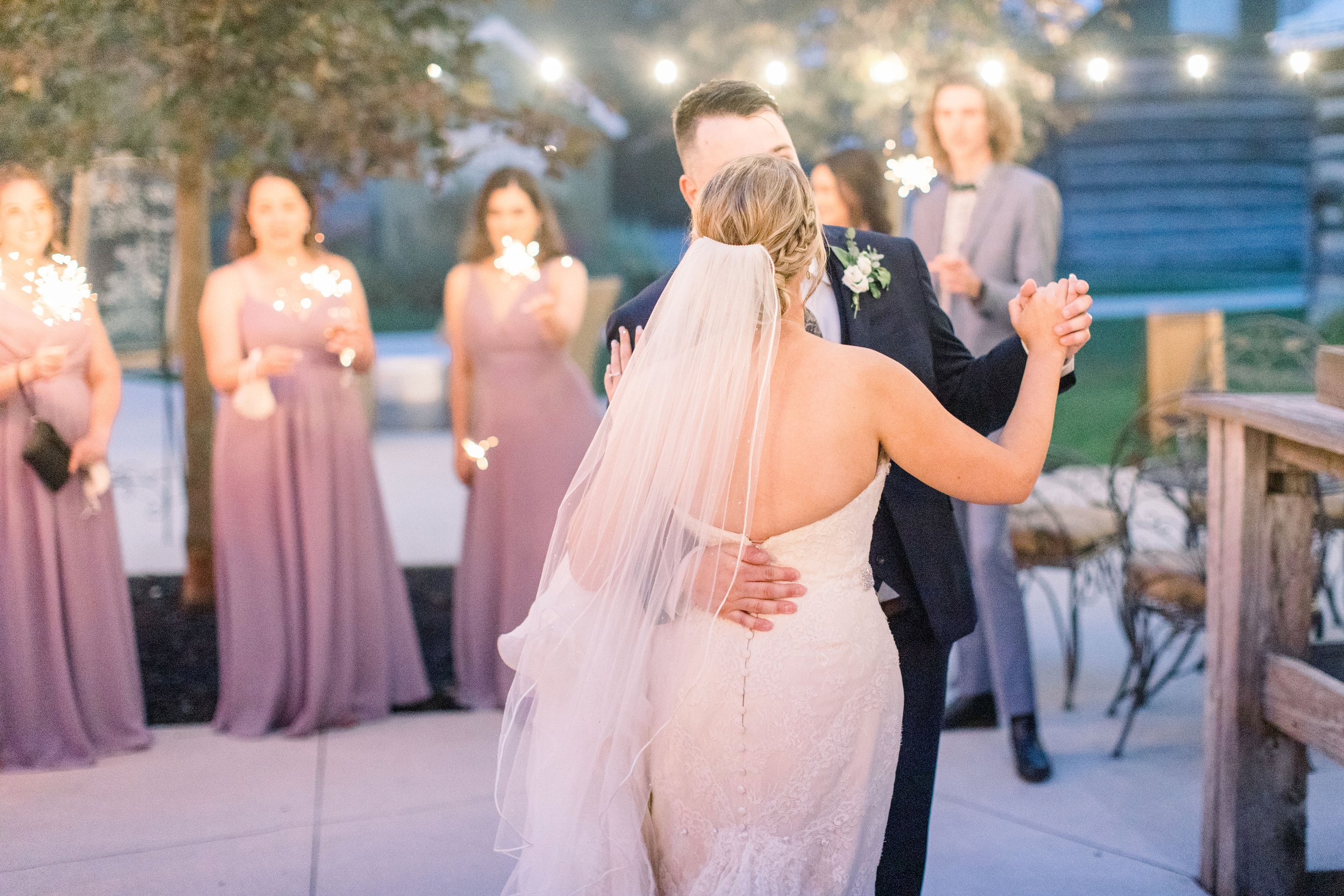  With lights above them, a bride and groom share their first dance by Chelsea Mason Photography. first dance as husband and wife #StonefieldEstates #Ontarioweddings #Chelseamasonphotography #Chelseamasonengagements #Ontarioweddingphotographers 