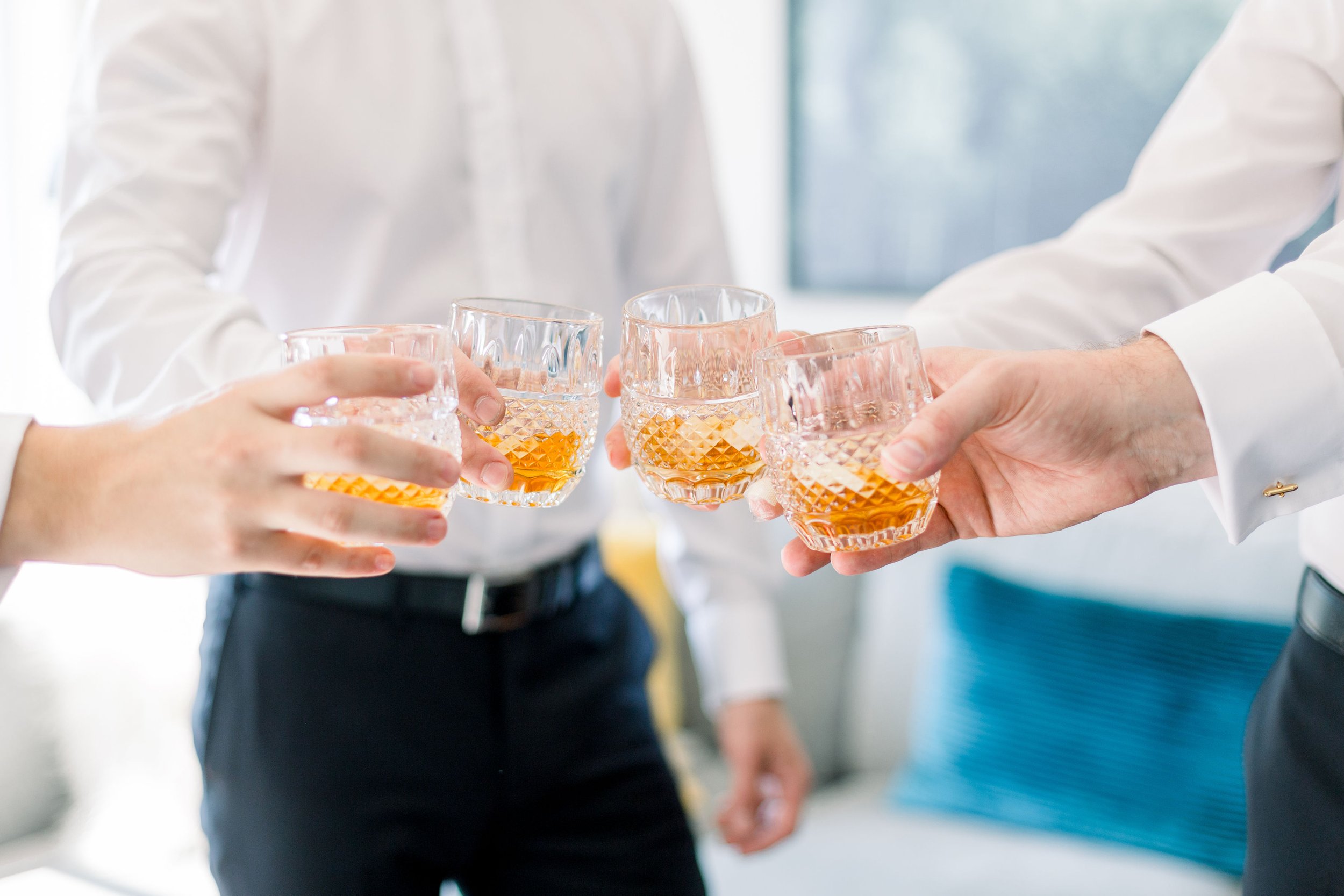  Groomsmen toast while getting ready for the wedding captured by Chelsea Mason Photography in Sandbanks. gentlemen getting ready wed #ChelseaMasonPhotography #ChelseaMasonWeddings #PrinceEdwardsCountryWeddings #SandbanksWeddings #ONweddingphotographe