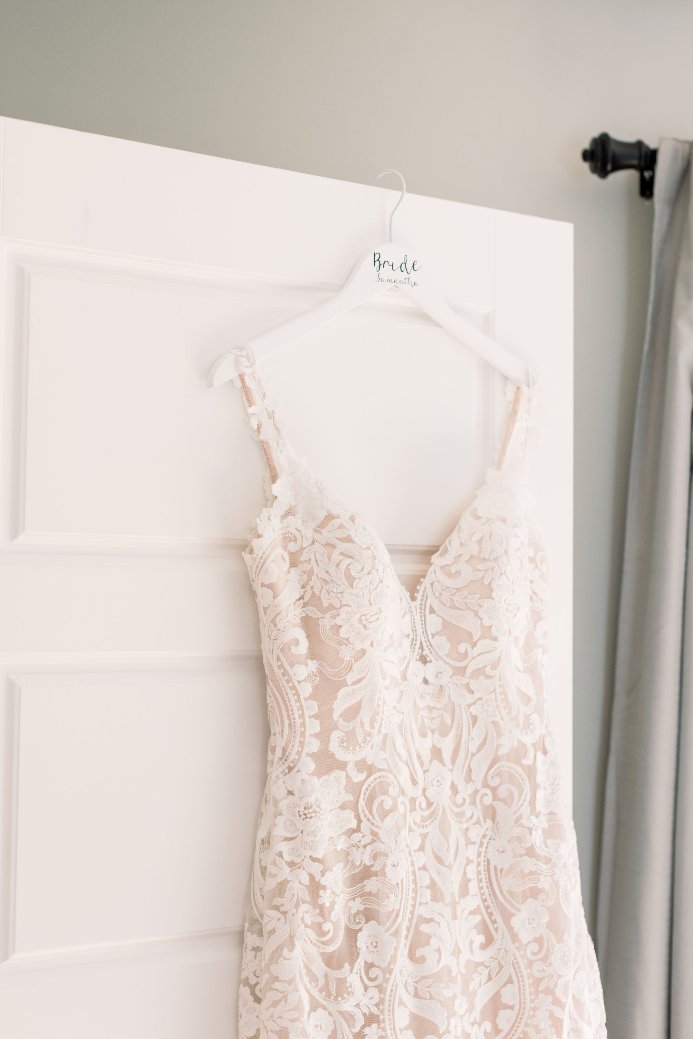  Bridal gown hanging up in the bridal room by Chelsea Mason Photography in Sandbanks, ON. lace wedding gown bridal suite #ChelseaMasonPhotography #ChelseaMasonWeddings #PrinceEdwardsCountyWeddings #SandbanksWeddings #ONweddingphotographer 