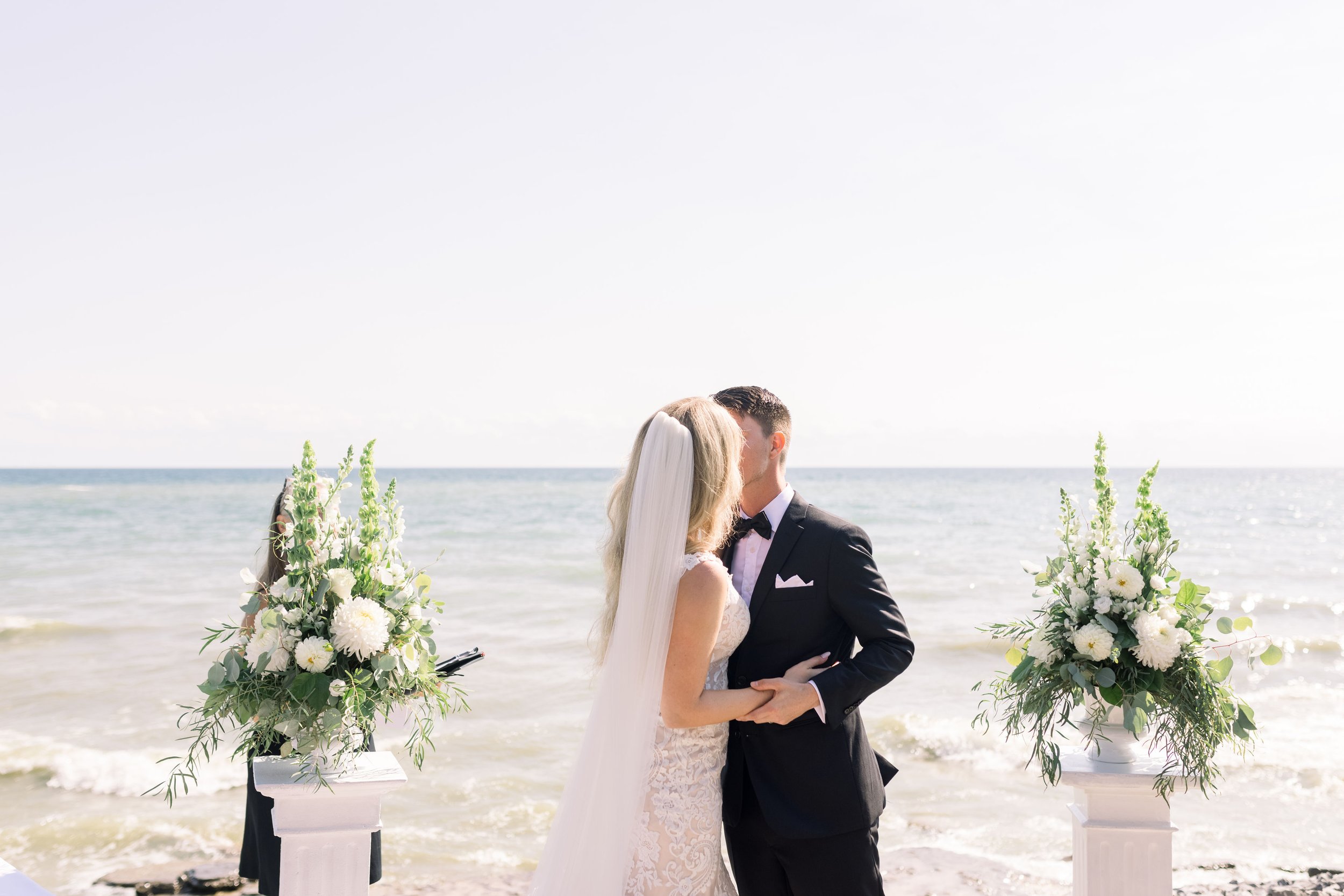  Chelsea Mason Photography captures a bride and groom's first kiss as a married couple. Prince Edwards County Weddings first kiss #ChelseaMasonPhotography #ChelseaMasonWeddings #PrinceEdwardsCountyWeddings #SandbanksWeddings #ONweddingphotographer 