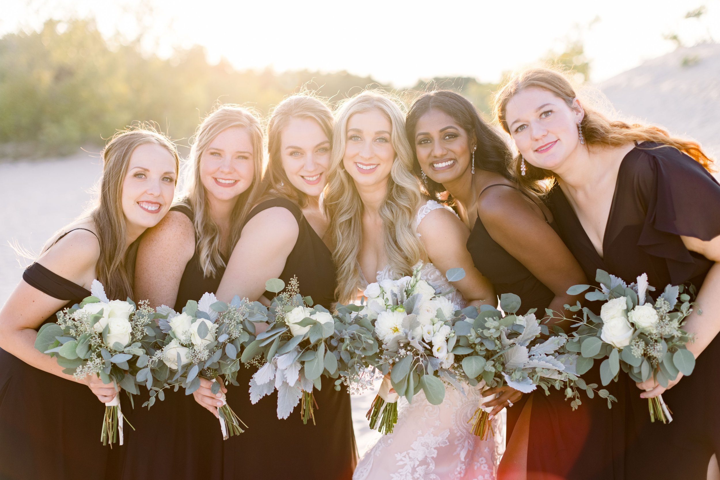  Chelsea Mason Photography captures a bride with her bridesmaids at sunset on the beach. classic wedding colors sunset wedding #ChelseaMasonPhotography #ChelseaMasonWeddings #PrinceEdwardsCountyWeddings #SandbanksWeddings #ONweddingphotographer 