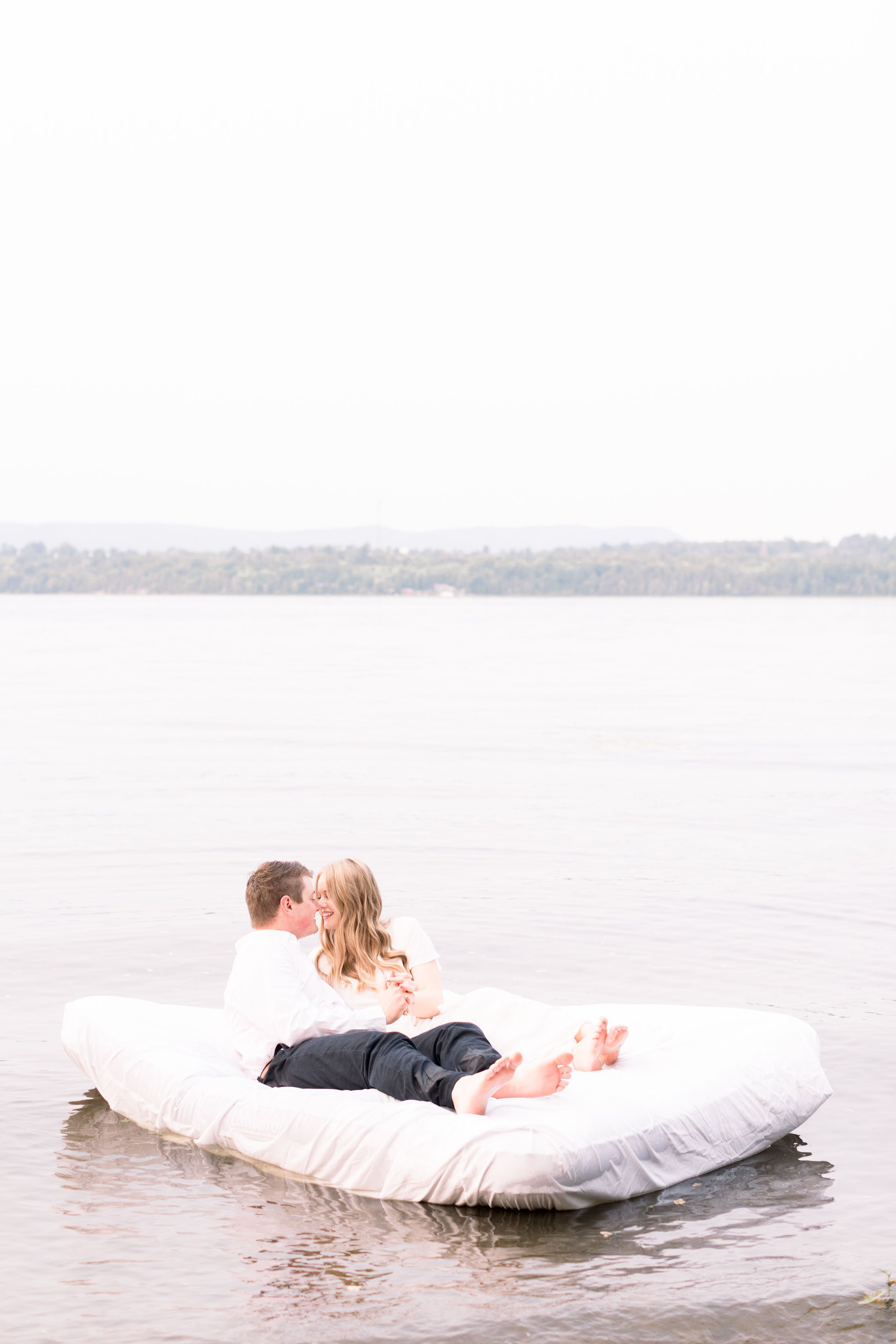  An engaged couple floats on an air mattress on a lake by Chelsea Mason Photography. floating on a lake engagements Lake engagements Ottawa #ChelseaMasonPhotography #ChelseaMasonEngagements #PinheysPointEngagements #OttawaEngagementPhotography 