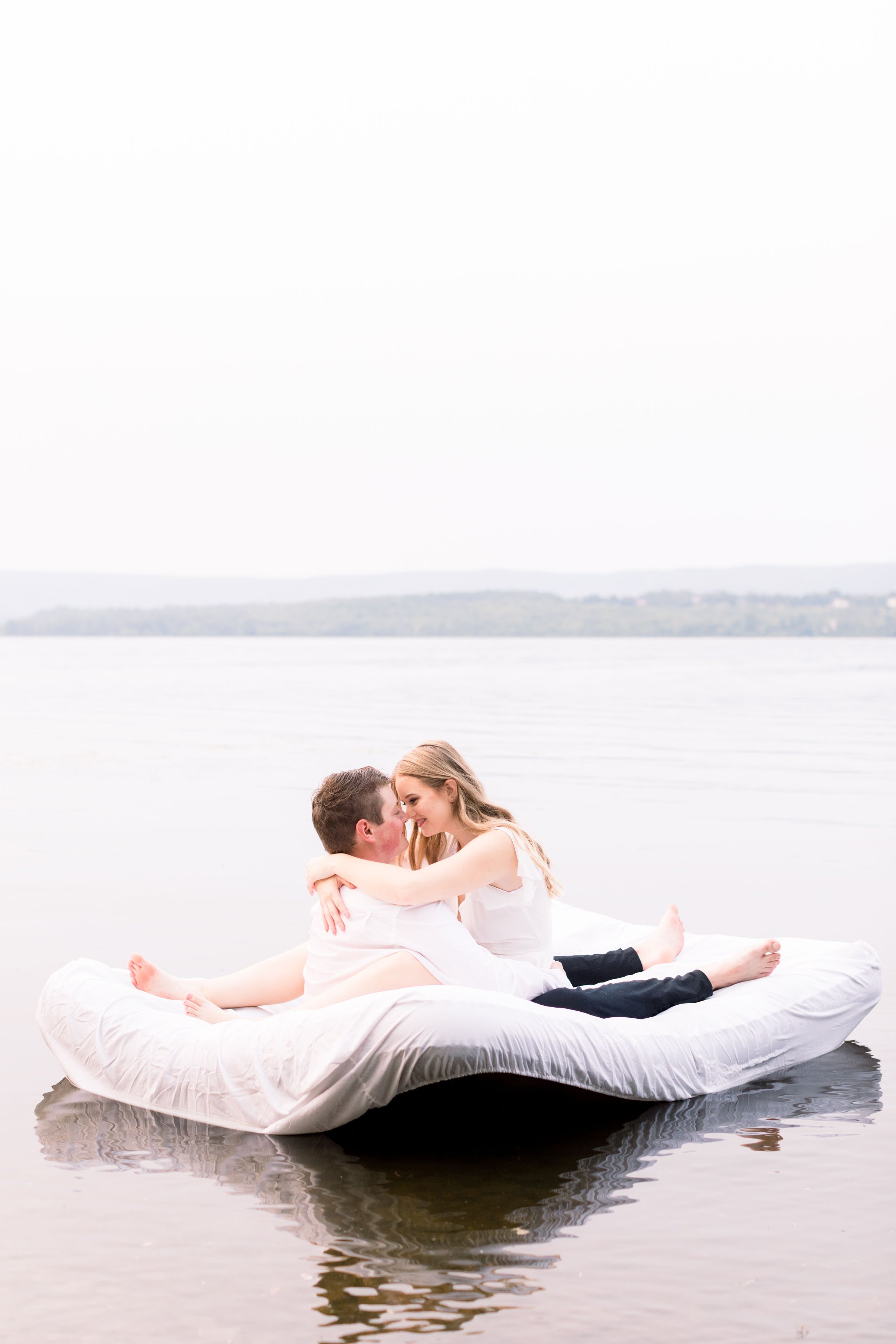  Soon-to-be Married couple kisses intimately on a lake by Chelsea Mason Photography. married couple kissing fiances Engagement Photography #ChelseaMasonPhotography #ChelseaMasonEngagements #PinheysPointEngagements #OttawaEngagementPhotography 