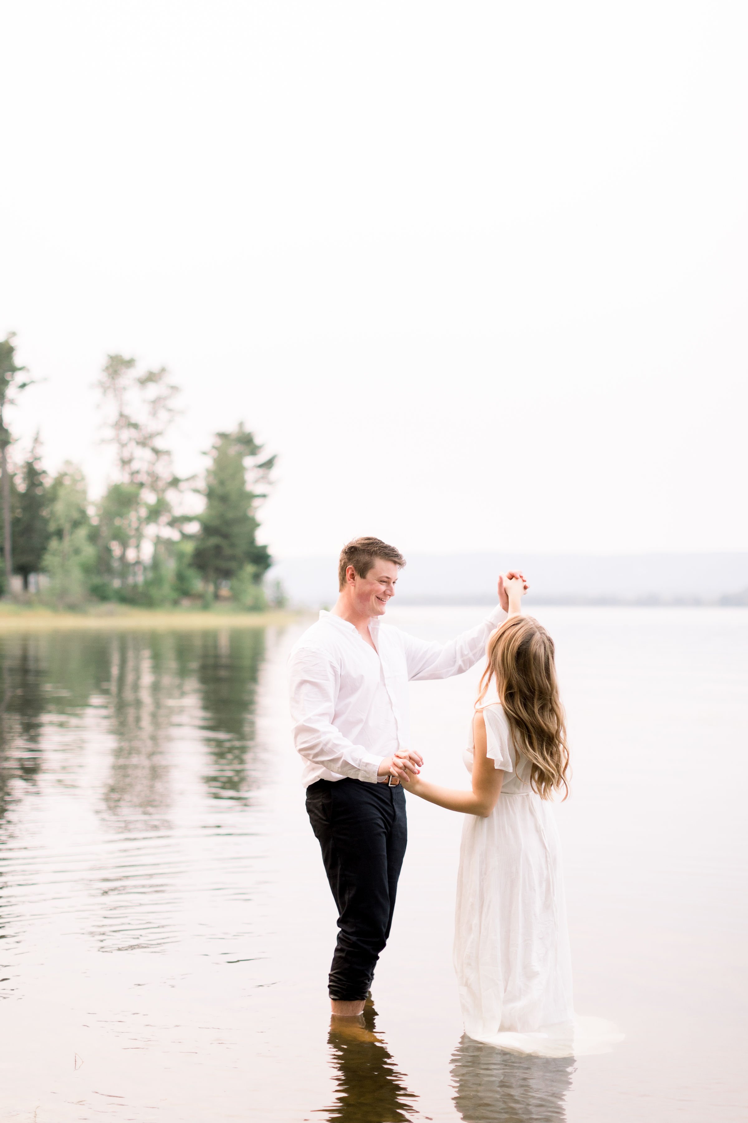  Husband and wife to be, dance in the shallow part of a lake captured by Chelsea Mason Photography. dancing portraits dreamy engagement pictures #ChelseaMasonPhotography #ChelseaMasonEngagements #PinheysPointEngagements #OttawaEngagementPhotography 