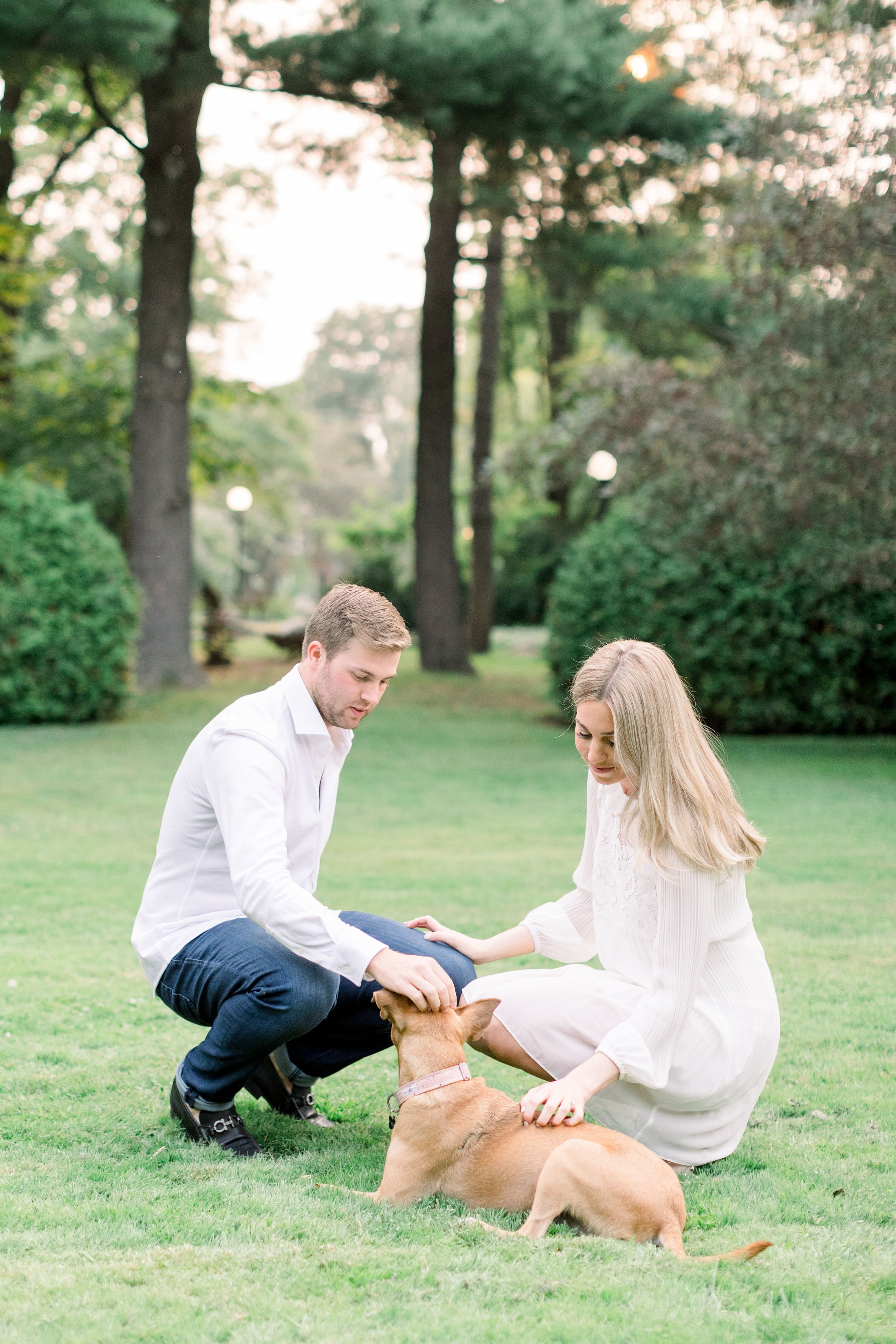  During an engagement session, Chelsea Mason Photography captures a man and woman petting their dog. dog in wedding pictures #Ottawaengagements #Ottawaweddingphotographers #engagementwithdogs #ChelseaMasonPhotography #ChelseaMasonEngagements  