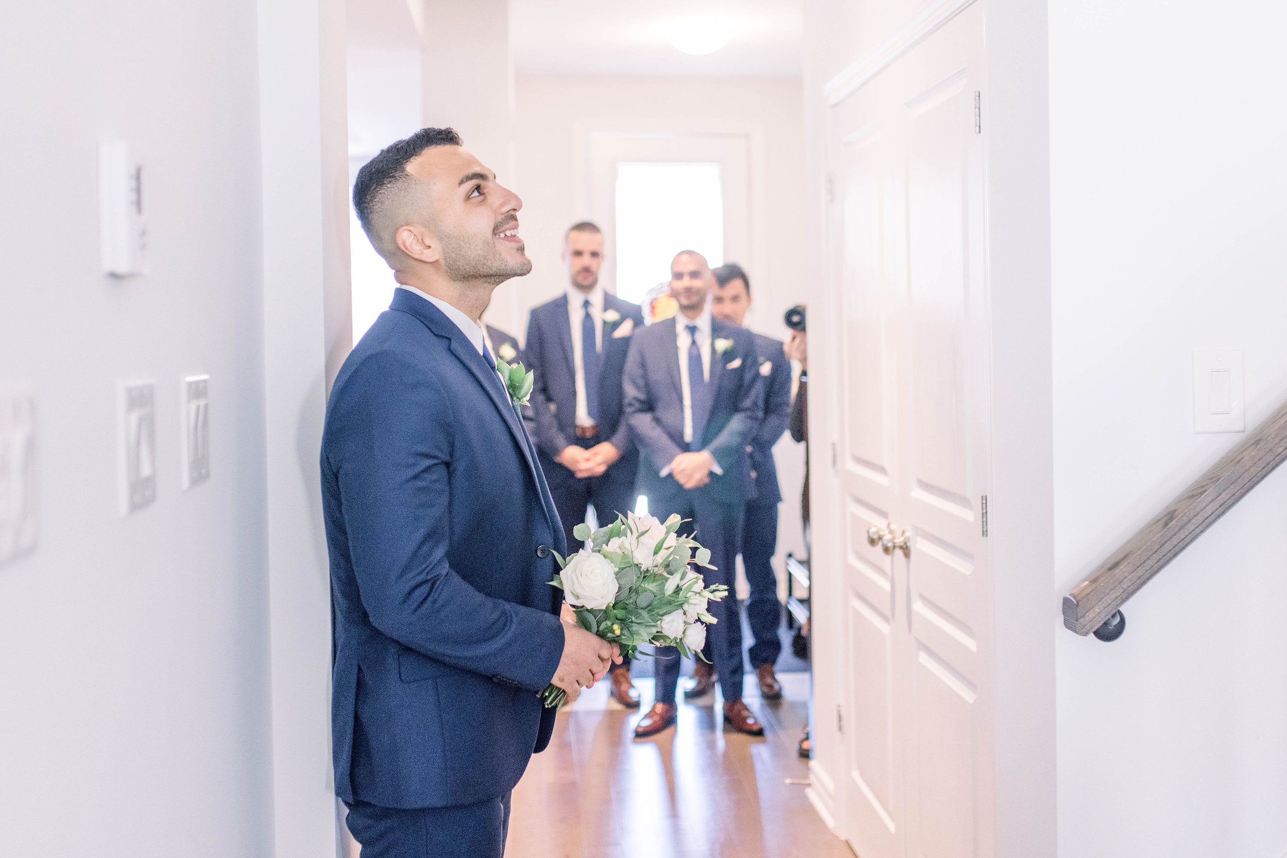  Groom watches his bride come down the stairs with her father by Chelsea Mason Photography. Ottawa wedding photog traditions #ChelseaMasonPhotography #ChelseaMasonWeddings #DowntownOttawa #FairmontChateauLaurier #OttawaWeddings #OttawaPhotographers 