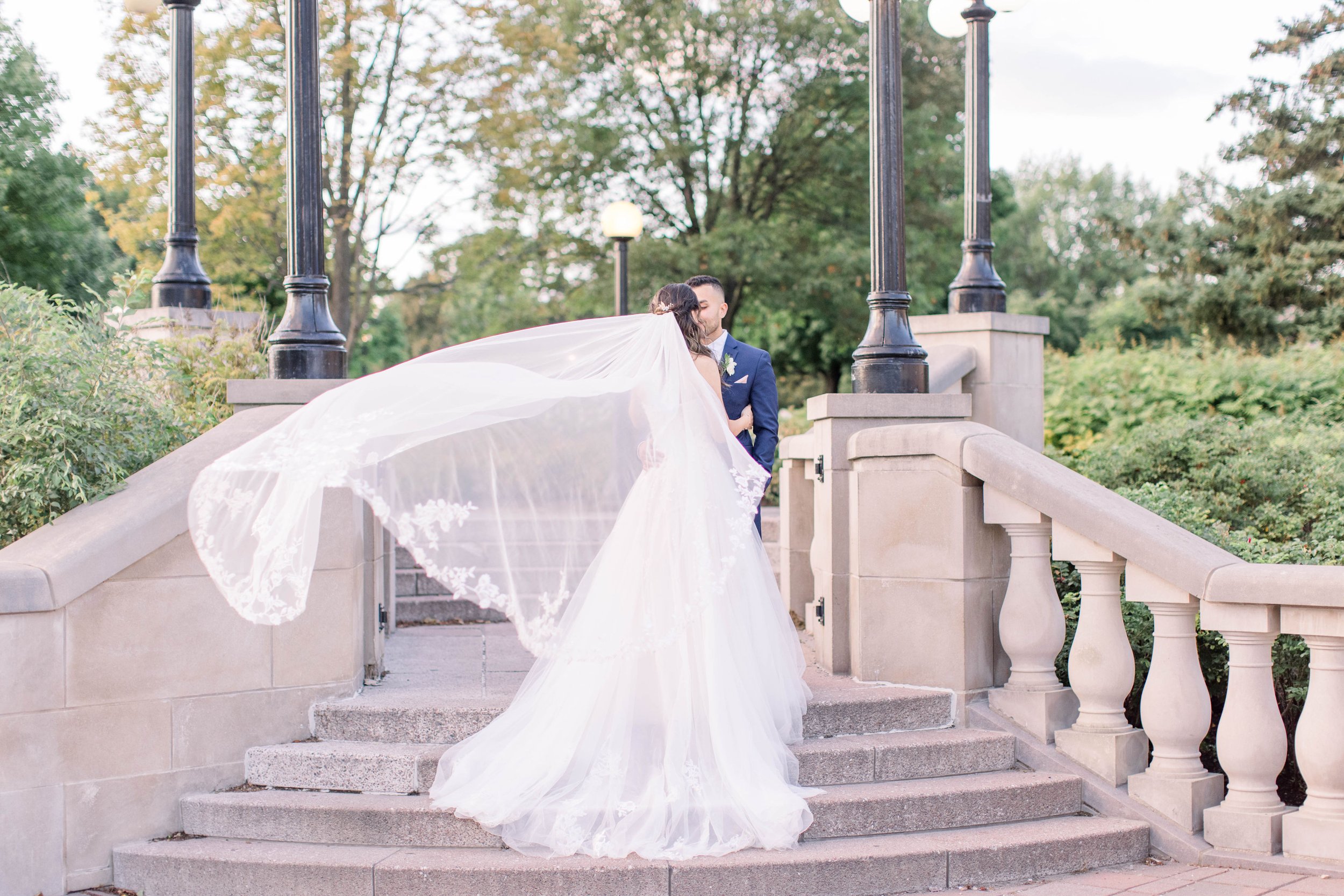  Ottawa professional photographer captures newlyweds kissing with a veil blowing by Chelsea Mason Photography. veil portraits #ChelseaMasonPhotography #ChelseaMasonWeddings #DowntownOttawa #FairmontChateauLaurier #OttawaWeddings #OttawaPhotographers 