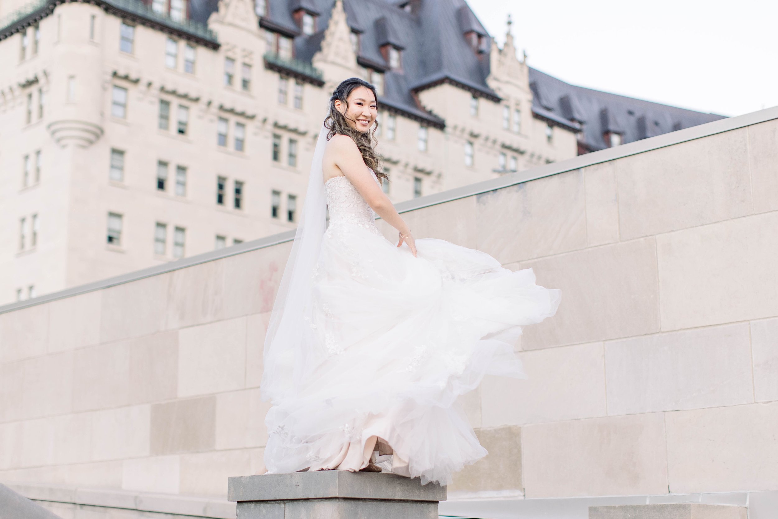  Chelsea Mason Photography captures a bride looking like a princess with a castle behind her. princess bridal portraits #ChelseaMasonPhotography #ChelseaMasonWeddings #DowntownOttawa #FairmontChateauLaurier #OttawaWeddings #OttawaPhotographers 