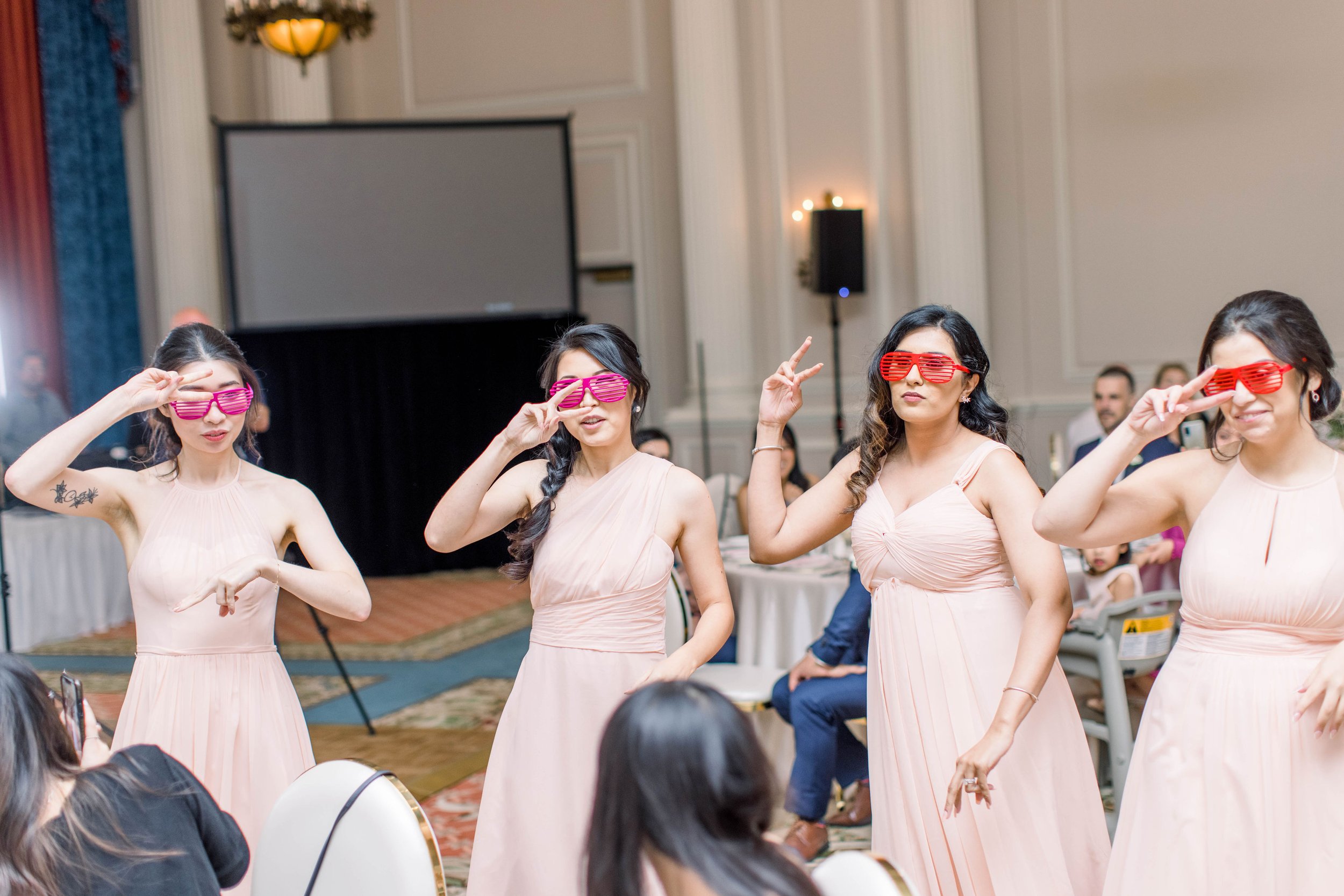  Bridesmaids come into the wedding luncheon with glasses doing a dance by Chelsea Mason Photography. fun bridesmaids ideas #ChelseaMasonPhotography #ChelseaMasonWeddings #DowntownOttawa #FairmontChateauLaurier #OttawaWeddings #OttawaPhotographers 
