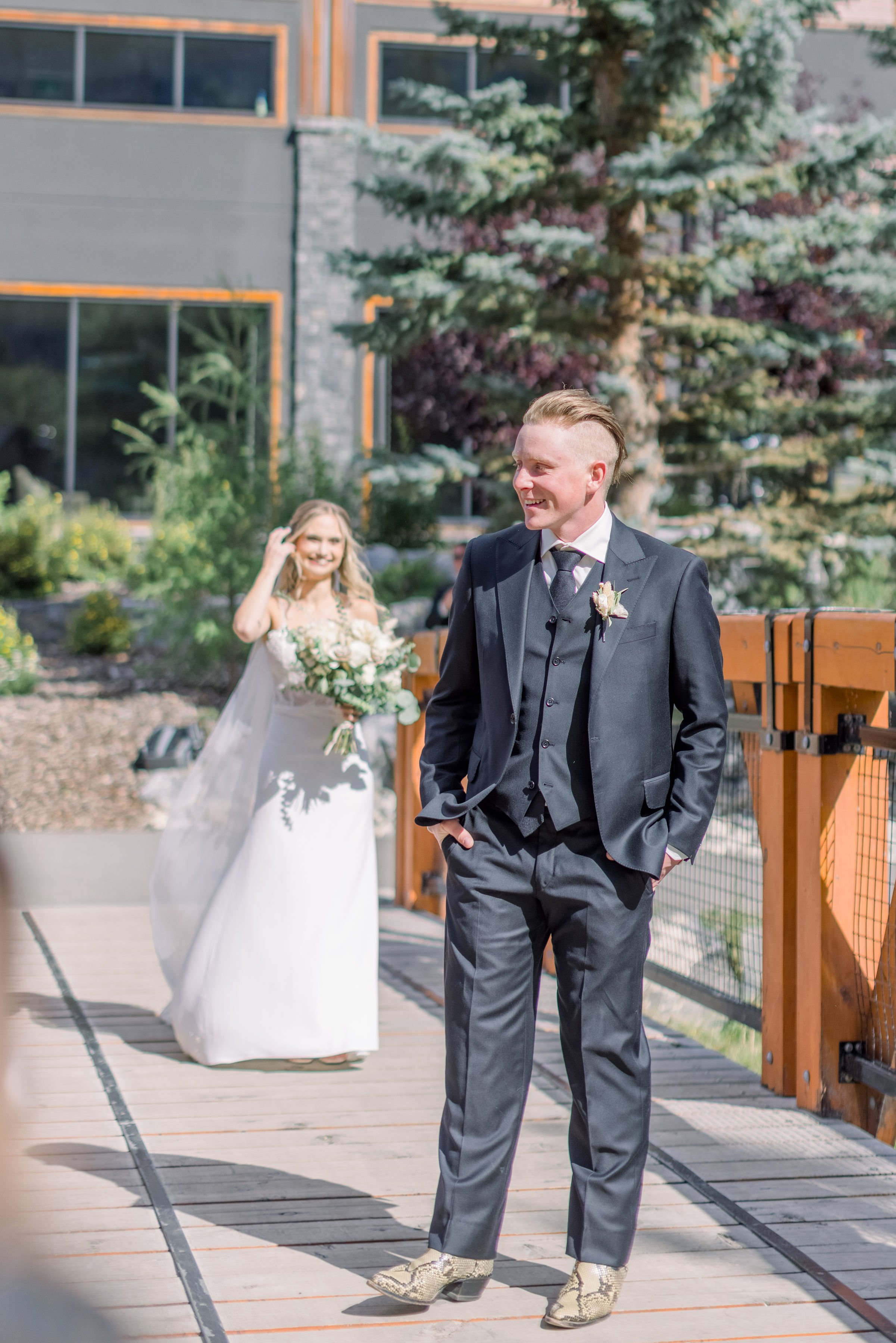  Groom stands getting ready for the first look at his bride-to-be by Chelsea Mason Photography. mountain wedding Canada #Albertaweddings #shesaidyes #Albertaweddingphotographers #SilvertipGolfCourse #ChelseaMasonPhotography #ChelseaMasonWeddings  