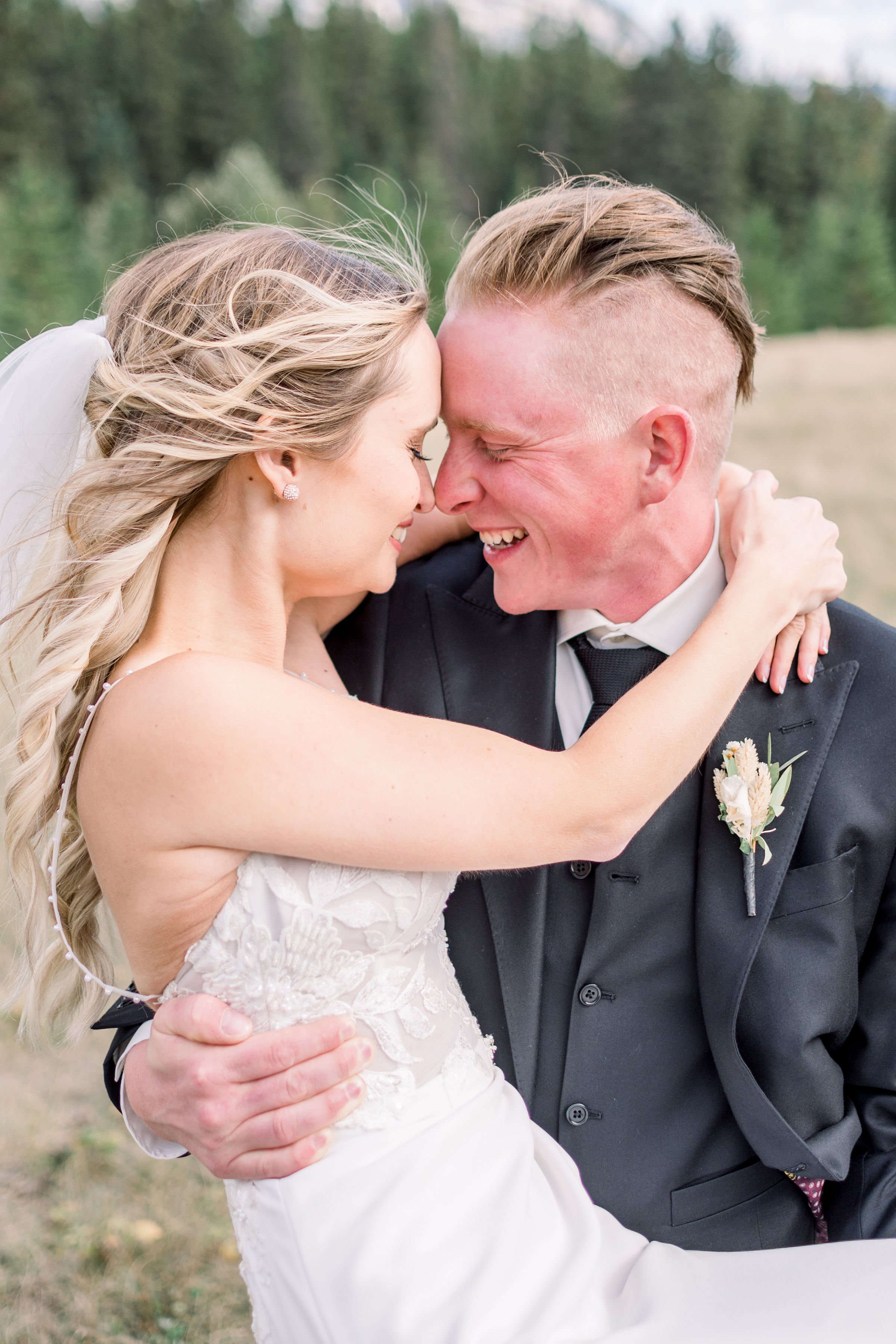  Groom holds his bride in his arm and goes in for a kiss by Chelsea Mason Photography. outdoor weddings wedding goals #Albertaweddings #shesaidyes #Albertaweddingphotographers #SilvertipGolfCourse #ChelseaMasonPhotography #ChelseaMasonWeddings  