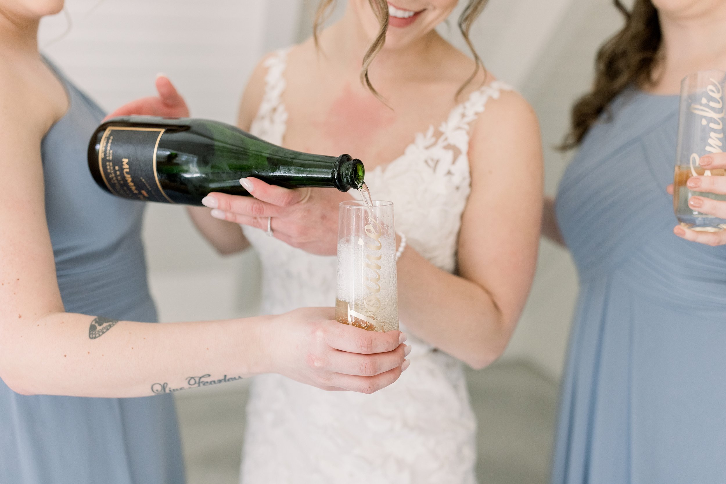  The bride pours champagne for her bridesmaids on her wedding day by Chelsea Mason Photography. celebrate wedding day #ChelseaMasonPhotography #ChelseaMasonWeddings #WakefieldWeddings #LeBelvedere #Wakefieldweddingphotographers 
