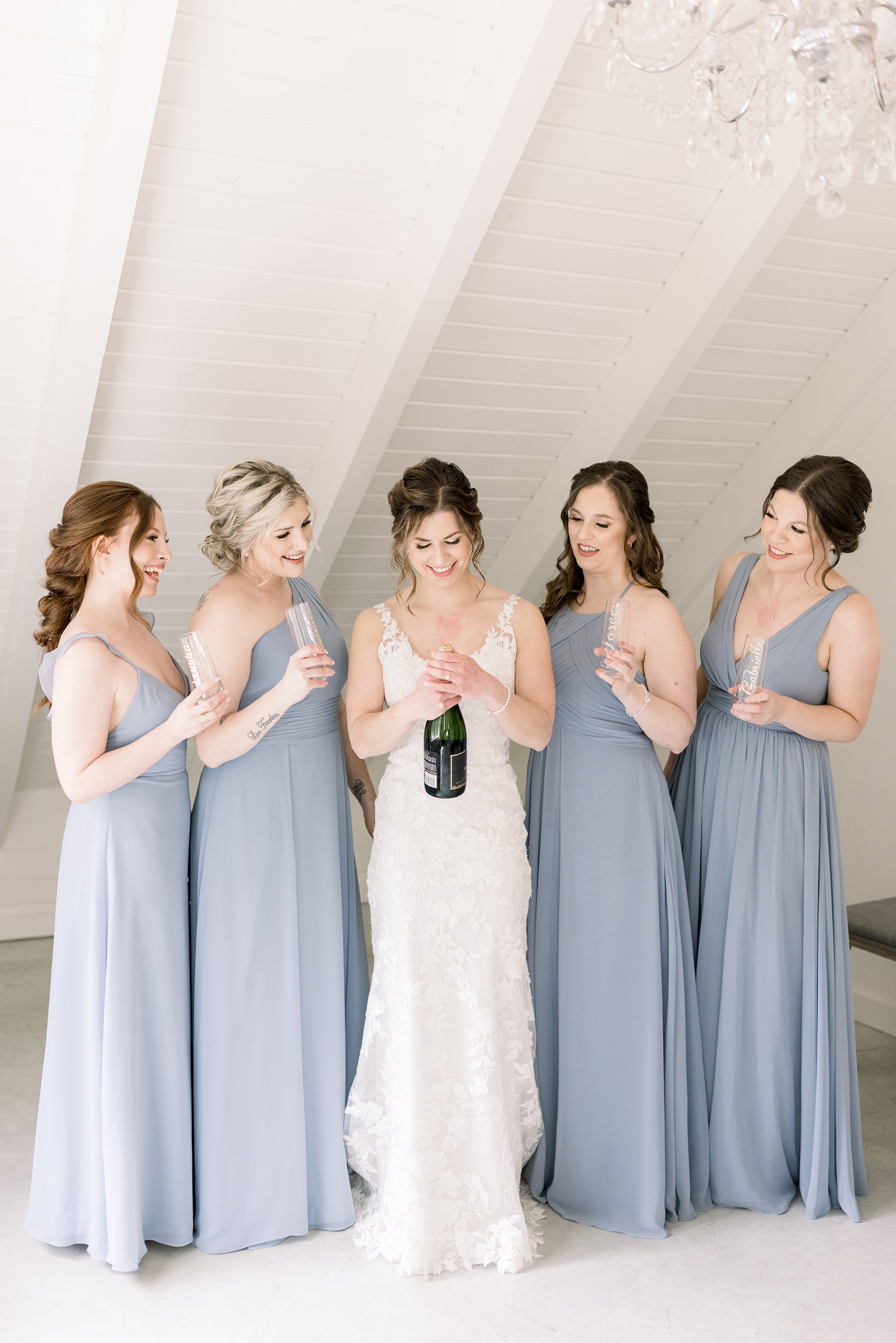  A bride with her bridesmaids all holding drinks to celebrate the wedding day by Chelsea Mason Photography. celebrate on wedding day #ChelseaMasonPhotography #ChelseaMasonWeddings #WakefieldWeddings #LeBelvedere #Wakefieldweddingphotographers 