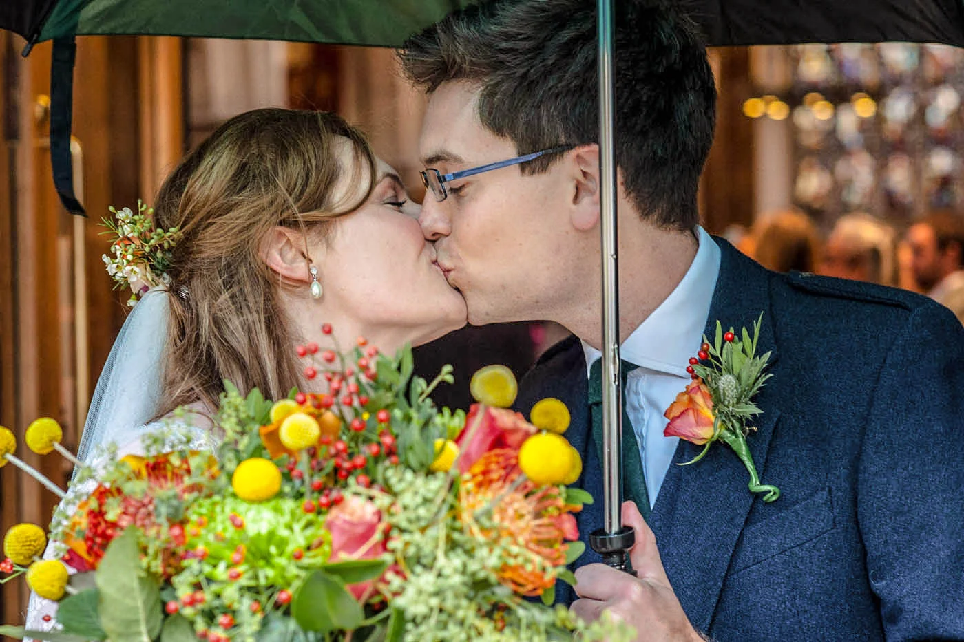 BRIDE-GROOM-KISS-UNDER-BROLLEY.jpg