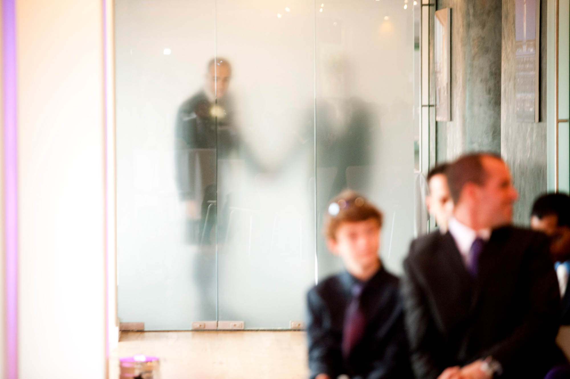 GROOM-PEAKS-INTO-ROOM-OXO-TOWER-WEDDING.jpg