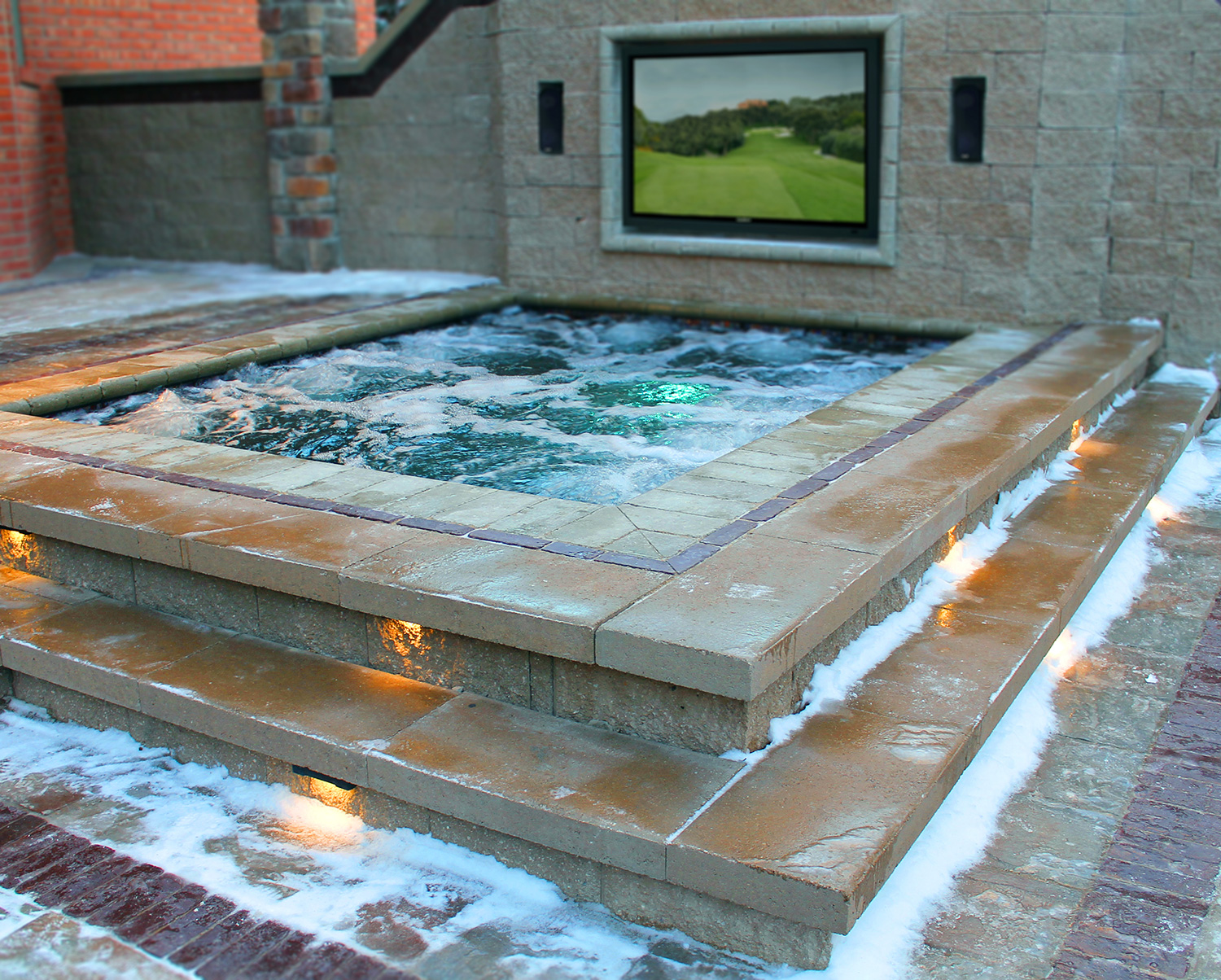 Custom inset spa with mounted all weather TV
