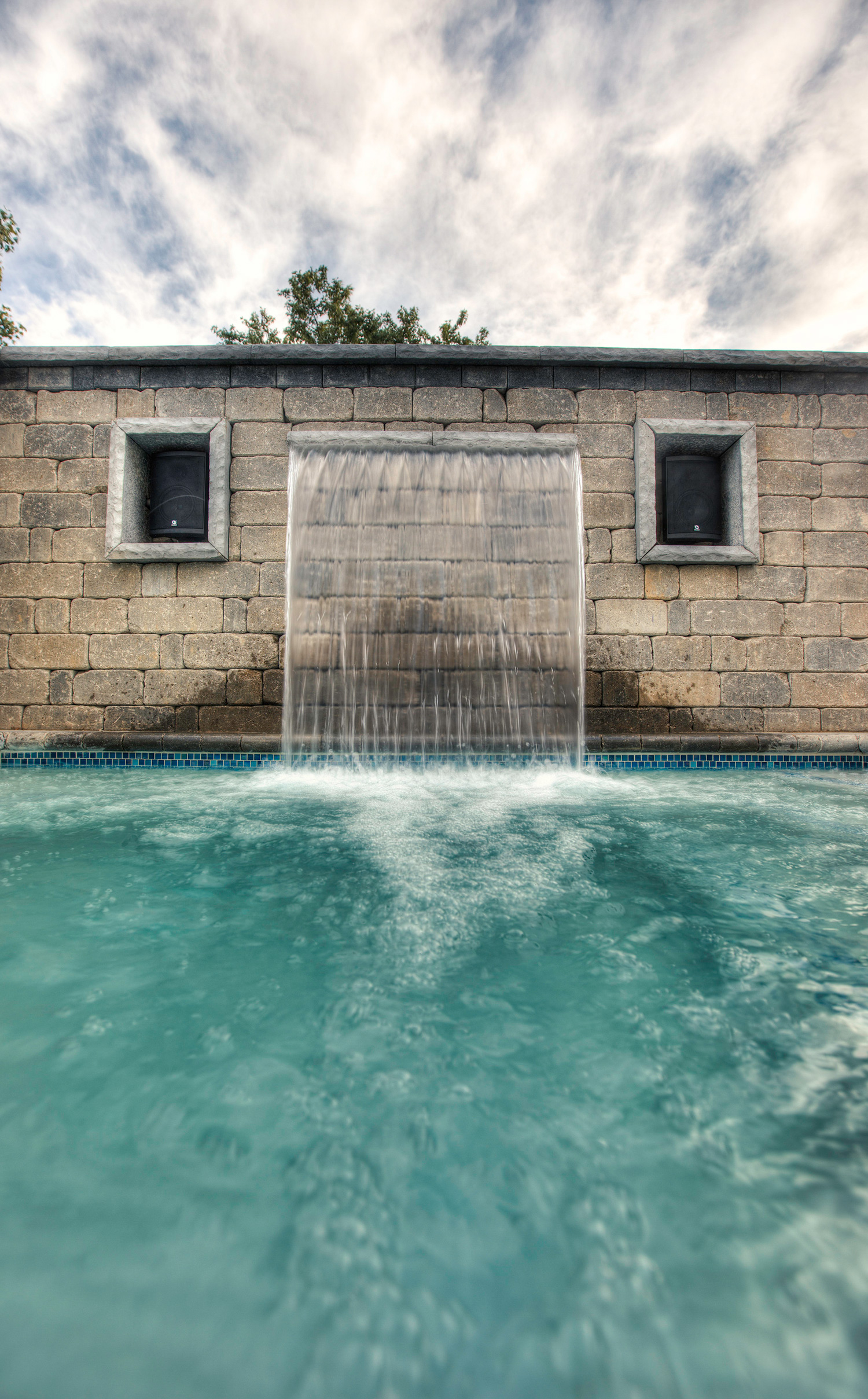 Custom inset spa with sheer decent water feature