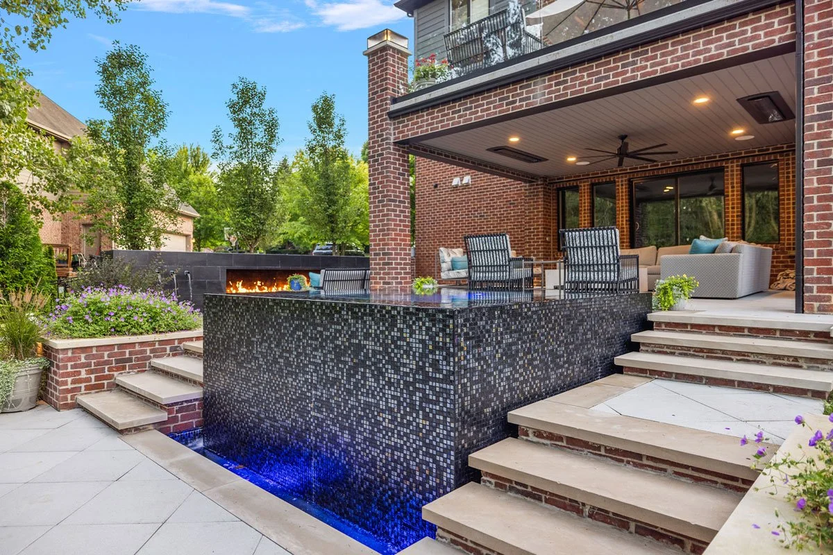 High-end residential swimming pool with subtle evening lighting and upscale backyard ambiance