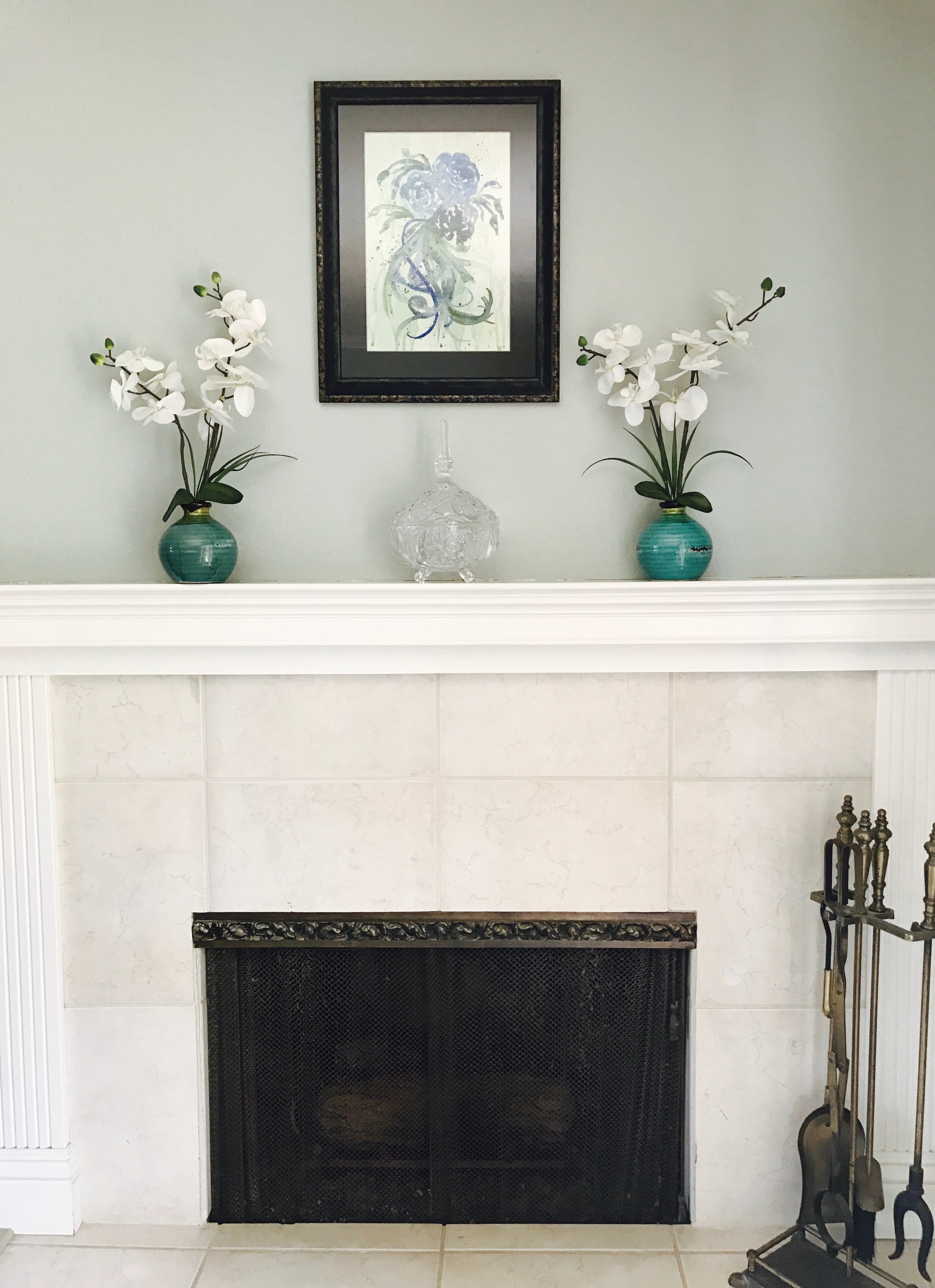 My living room fireplace with my original artwork, "Blue Roses." I love this little area of my home.