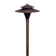 Coastal Source solid brass path light illuminating a Hamptons garden walkway