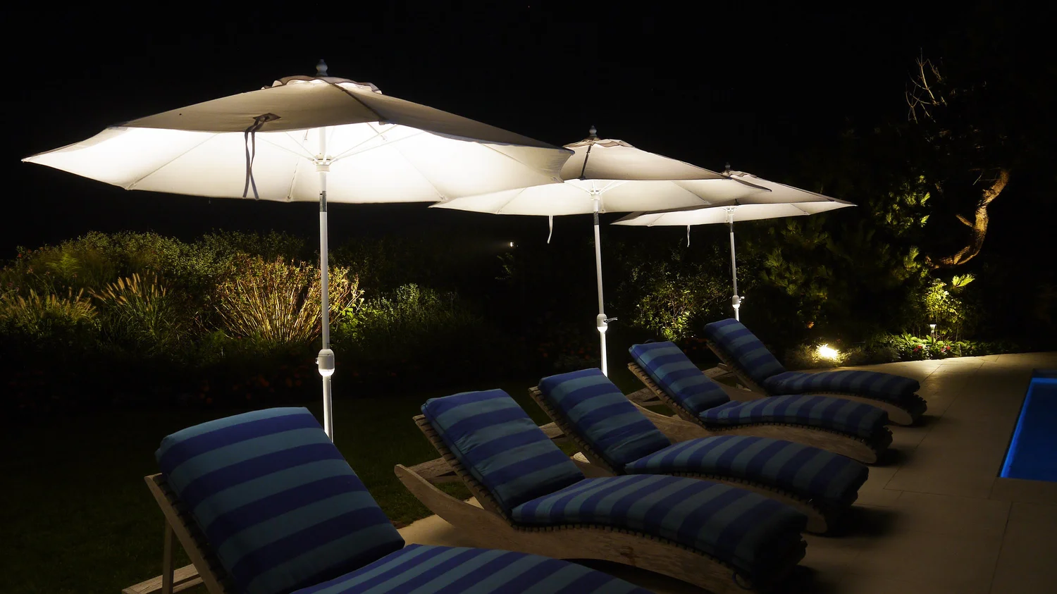 Landscape lighting scene at Southampton luxury estate — layered outdoor lighting across garden features