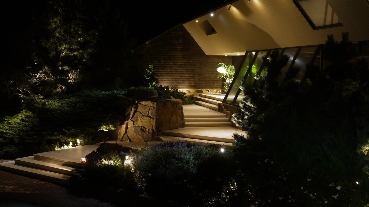 Garden lighting detail at Southampton Hamptons property — close-up of landscape fixture illuminating garden bed