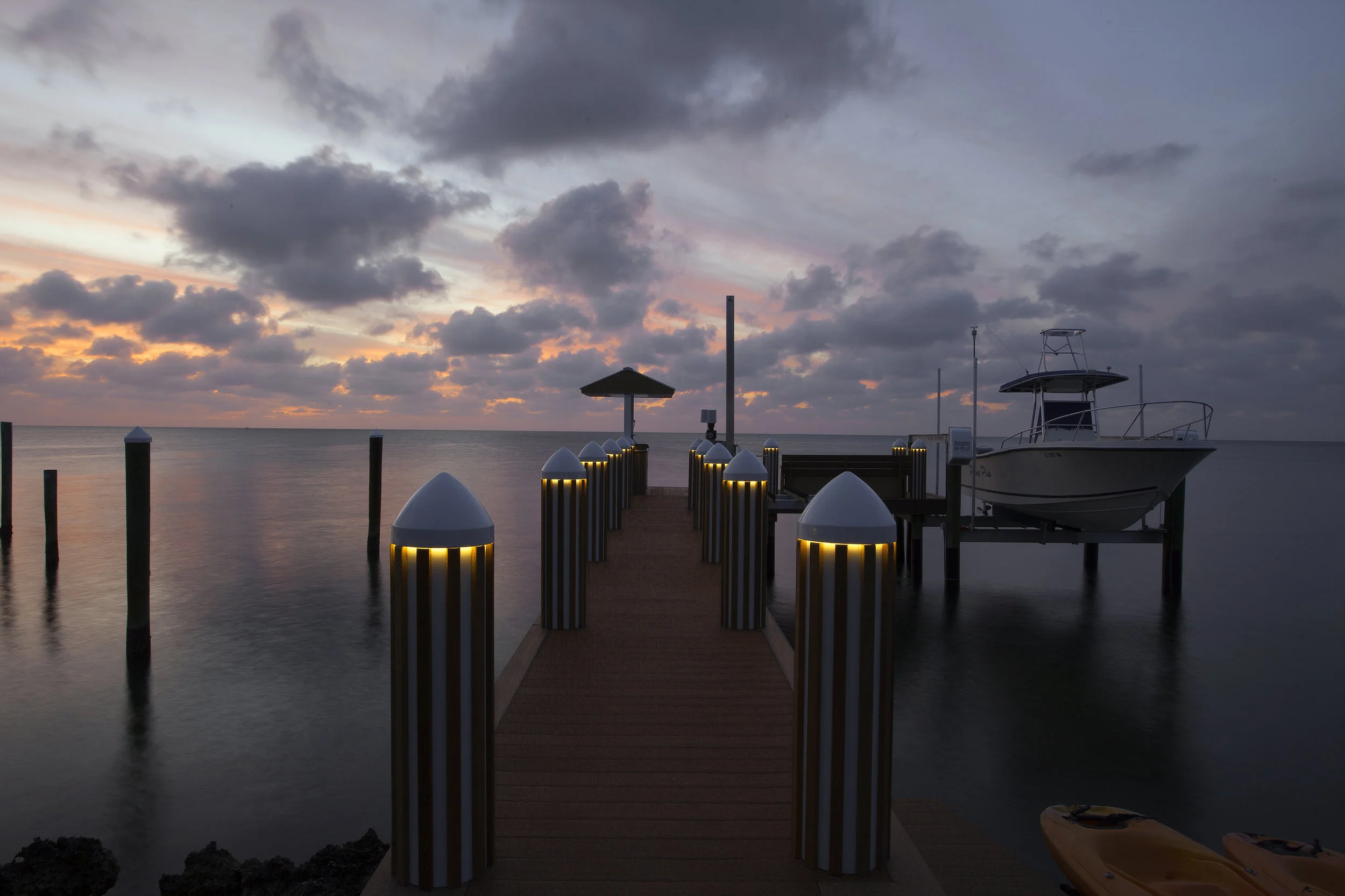 Southampton landscape lighting along a waterfront property at dusk